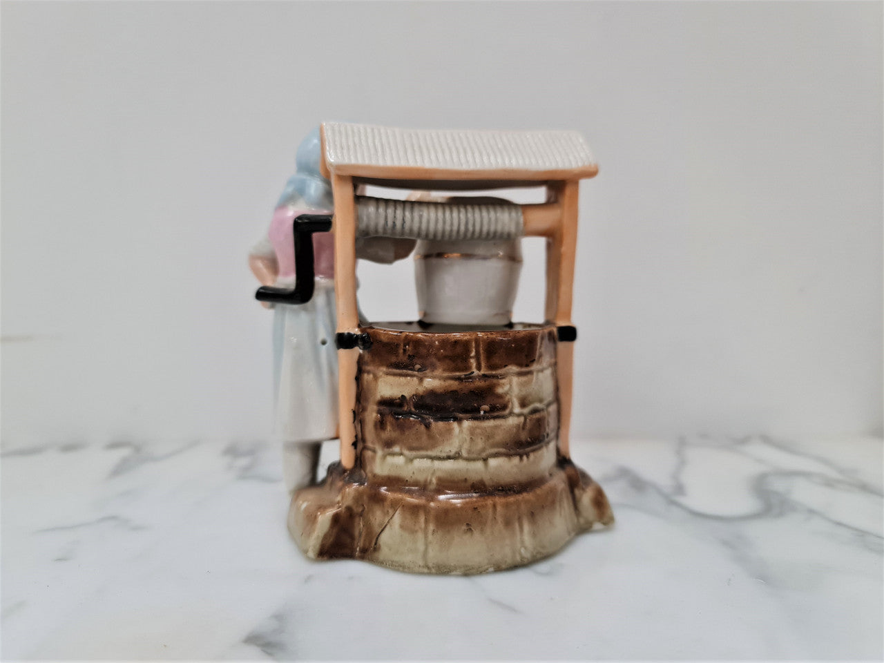 Stunning 19th Century wax match container & striker of girl at the well, it is numbered 4231.