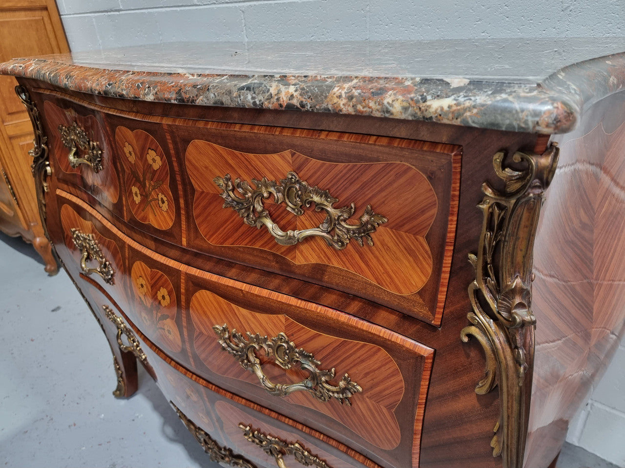 French Walnut and Kingwood Louis XV style marquetry inlaid commode with three drawers and a beautiful marble top. It is in good original detailed condition.