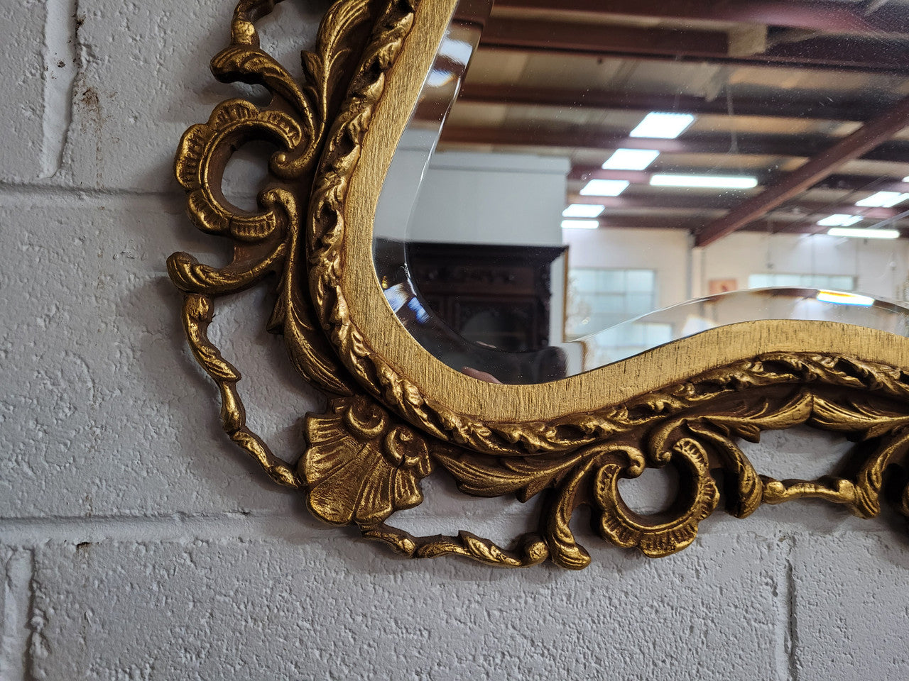 Large Vintage Italian carved wood gilt mirror. It has a beautiful bevelled mirror and has been sourced from France. It is in good original condition.