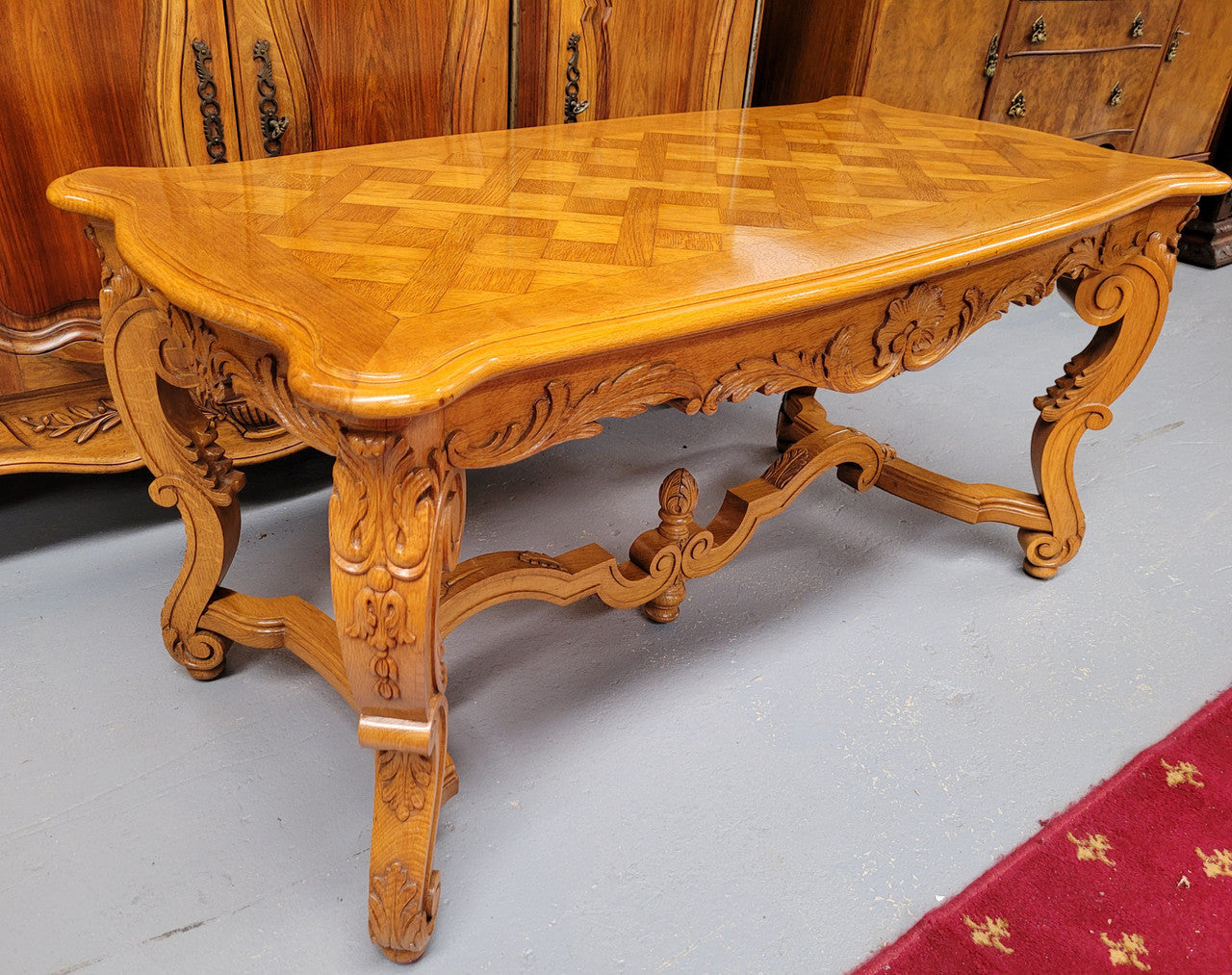 French Oak parquetry top coffee table with decorative carved base. It is in good original detailed condition.