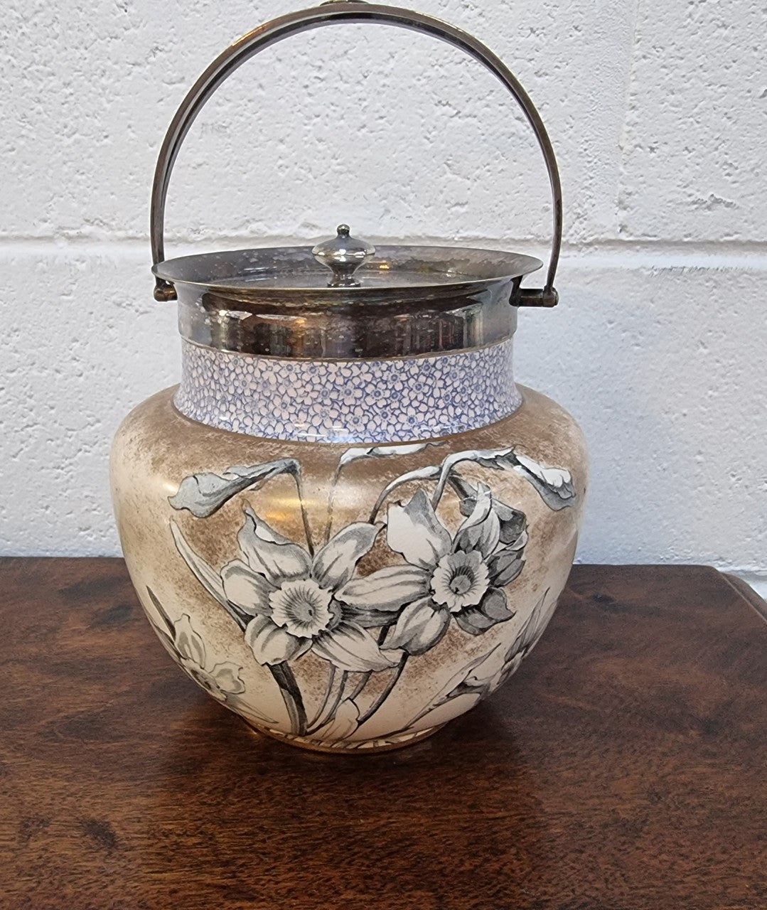 Royal Doulton Biscuit Barrel with silver plated top, handle and lid. Displaying a Daffodil pattern. In original condition please view photo's as they form part of the description.