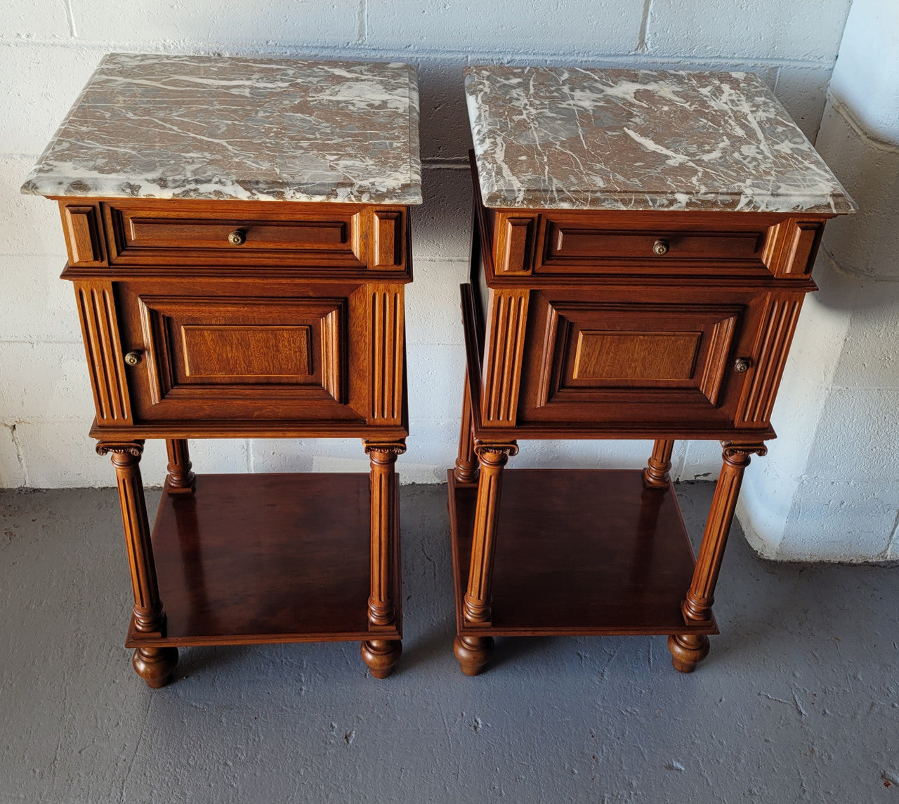 Pair of Henry II style Walnut bedside cabinets with a marble top. Circa 1920s and in good original condition.