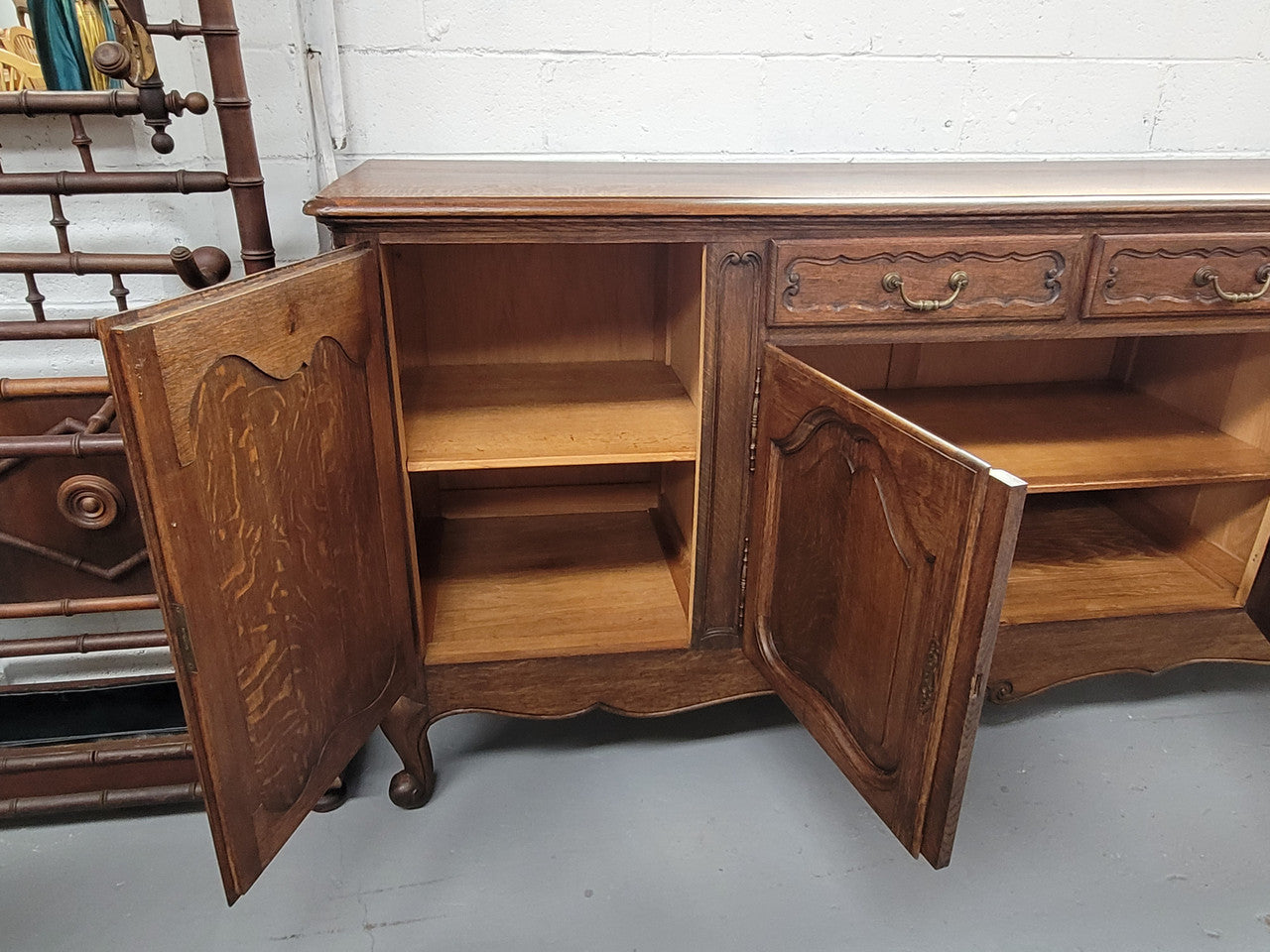 Louis XV style French Oak sideboard consisting of four doors and two drawers. It is in good restored condition.