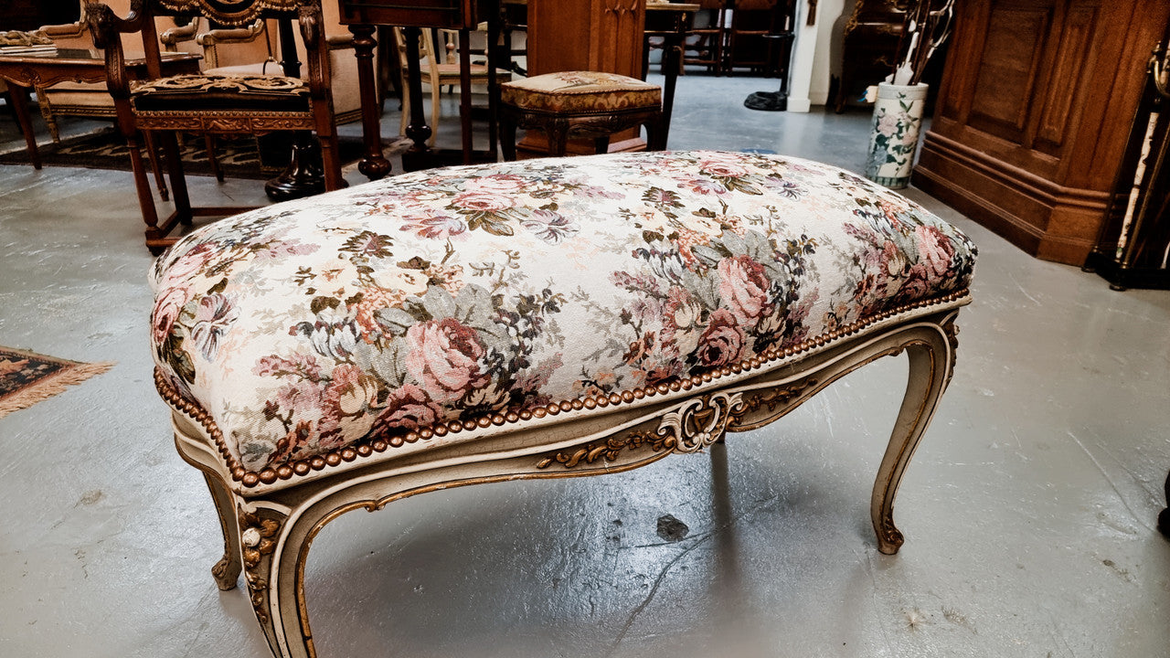 Antique painted Louis XV style upholstered stool. It has lovely floral upholstery that is in good condition with no tears. It is in good original detailed condition.