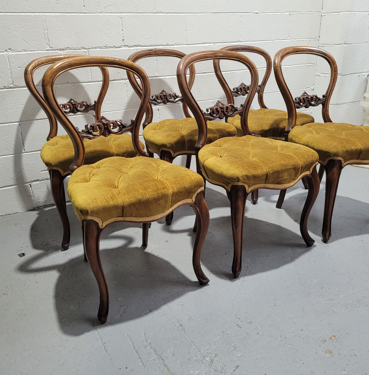 Set of six upholstered Victorian balloon back chairs. In good original detailed condition.