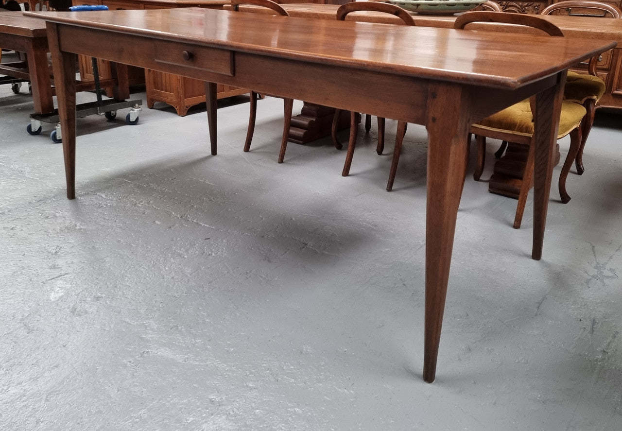 Antique French Oak Farmhouse table in fully restored condition. Features a single drawer and tapered legs.