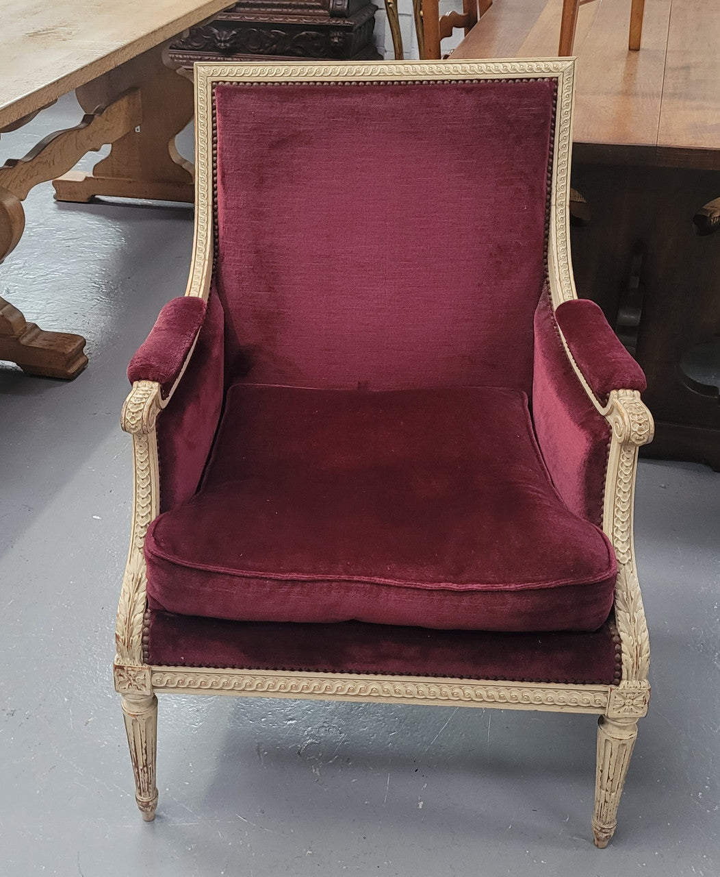 Louis 16th Style high back upholstered chair with maroon velvet fabric, decorative carvings and original paint. It has been sourced from France and in good original condition.