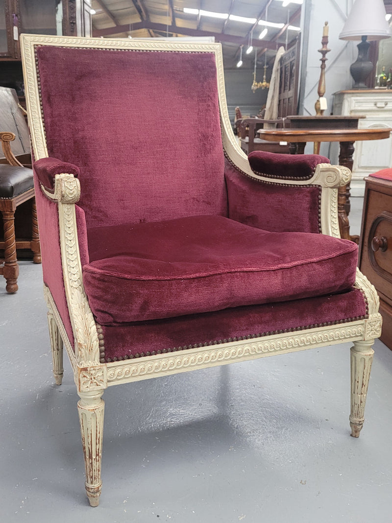 Louis 16th Style high back upholstered chair with maroon velvet fabric, decorative carvings and original paint. It has been sourced from France and in good original condition.