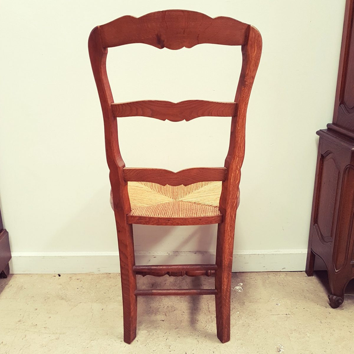 A set of six French Louis XV style, ladder back oak chairs. With finely carved detail and rush seat. In great original condition. Chairs are comfortable and sturdy for everyday use.