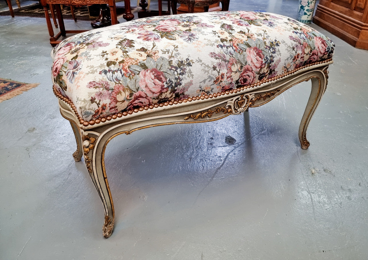 Antique painted Louis XV style upholstered stool. It has lovely floral upholstery that is in good condition with no tears. It is in good original detailed condition.