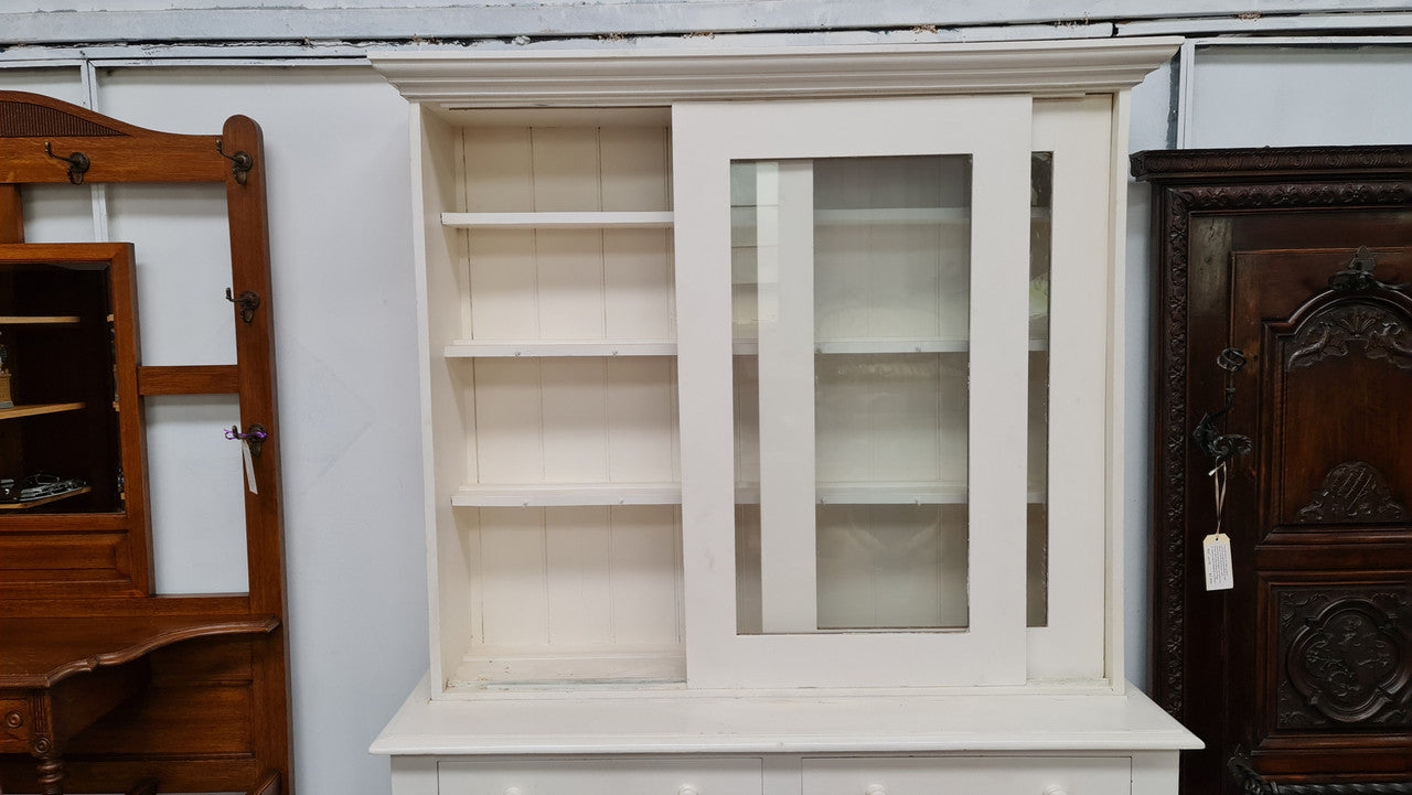 Australian painted two door kitchen hutch display and buffet cabinet. The top section has hooks and shelves. The bottom has two drawers along with cupboard space for added storage. In good original condition.