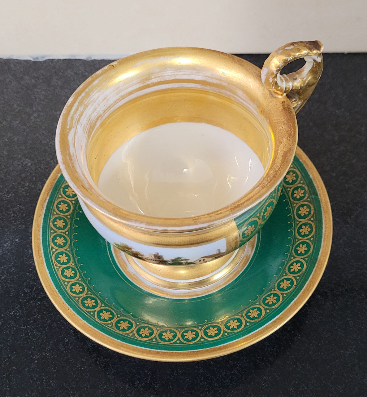 “Old Paris Porcelain” large cup and saucer with hand painted river landscape featuring castles. Gilt and enamel decoration. Circa: early 19th Century. In good original condition please view photos as they help form part of description.