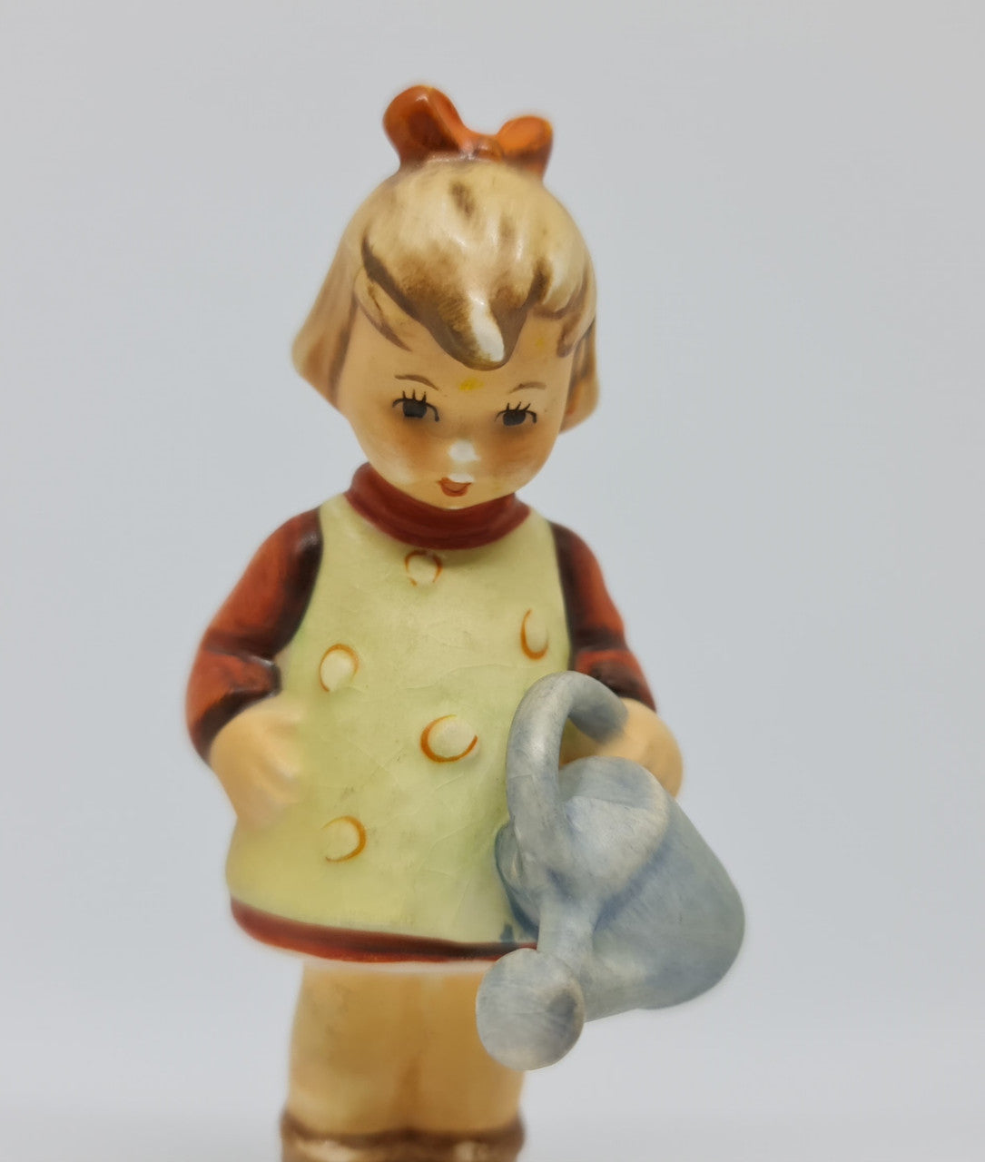 Gorgeous Hummel girl with watering can figurine, marked #74 . In great original condition.