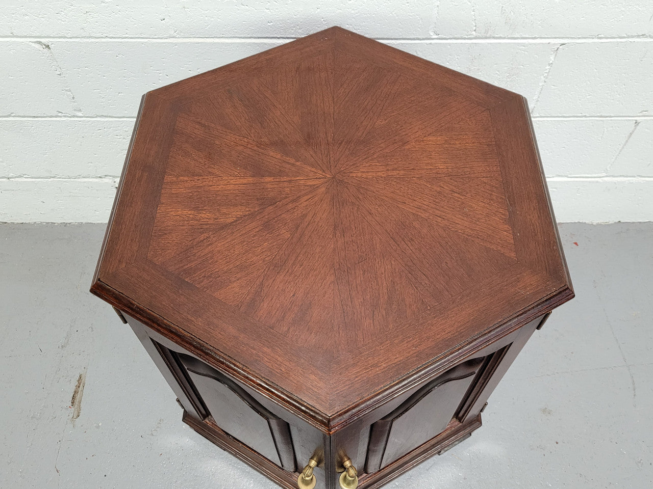 Hexagonal Mahogany enclosed side cabinet with two doors. Would make an ideal side cabinet and is in good restored condition.