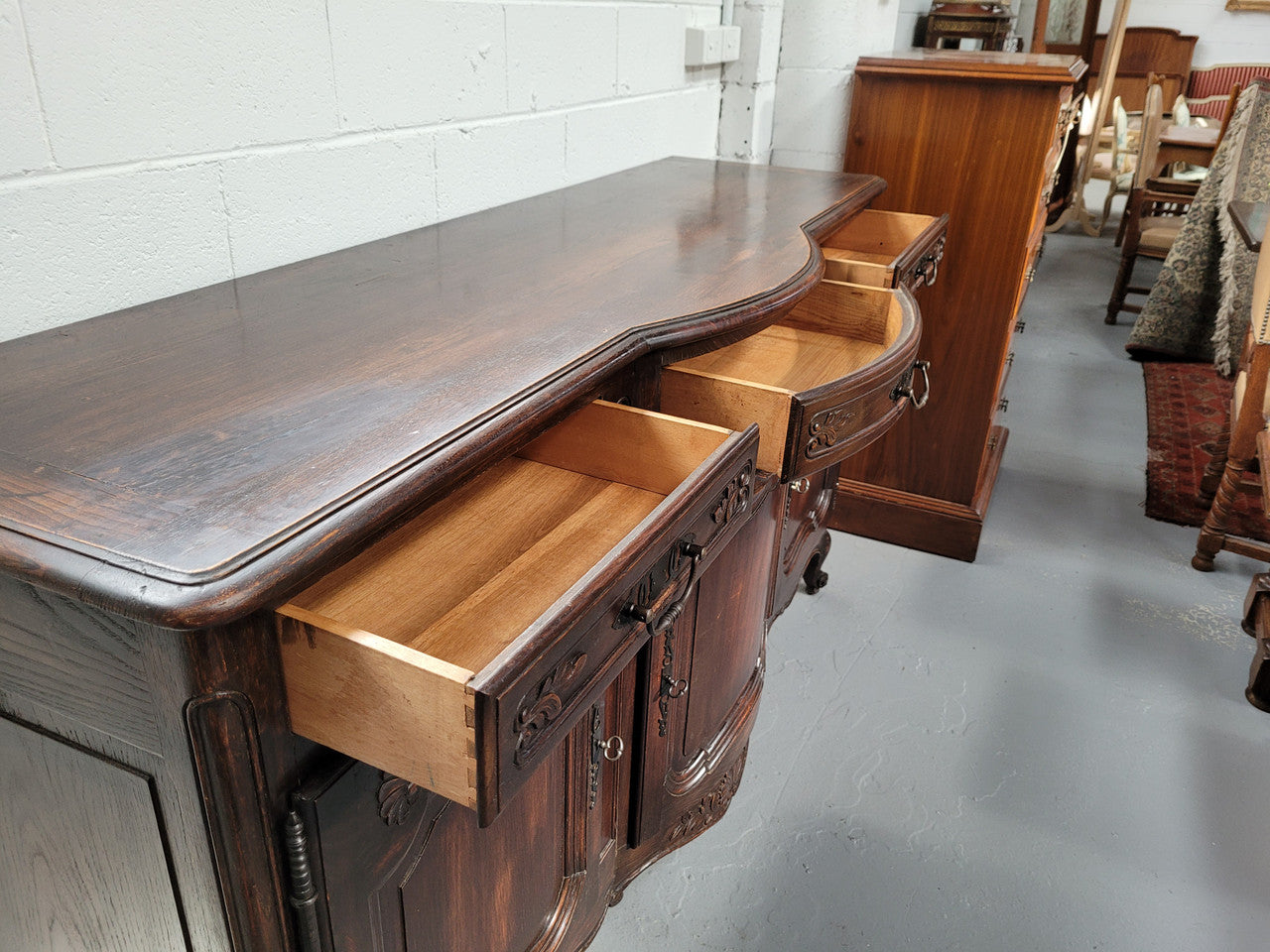 French dark oak three door and three drawer sideboard. Plenty of storage space and it is in good original detailed condition.