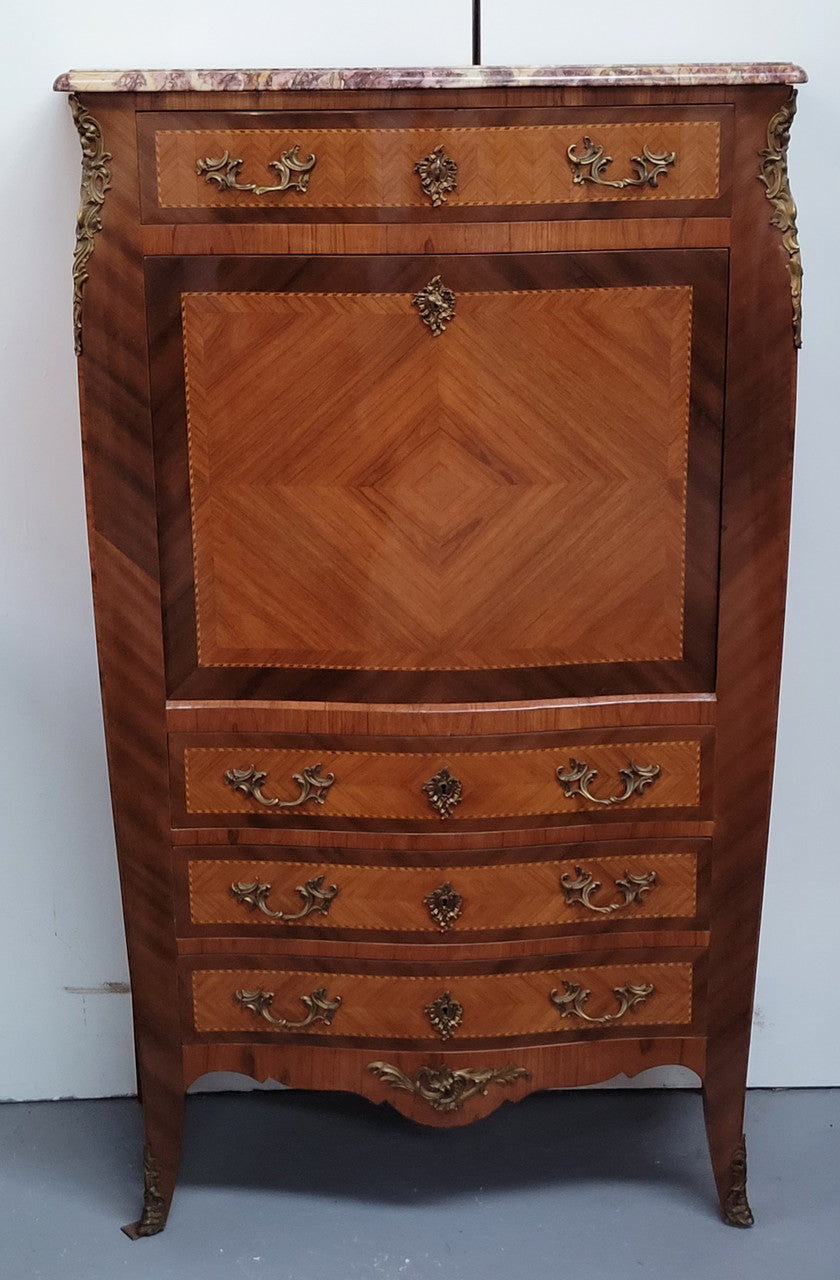 Walnut Louis XV style marble top abbattant with beautiful parquetry inlay and ormolu mounts. It has plenty of storage space with four large drawers and four smaller internal drawers. Beautiful drop down desk with a leather insert. In very good original detailed condition.