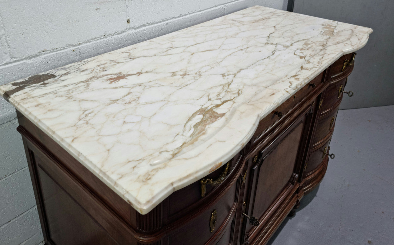 Fabulous French Walnut Louis XVI style cupboard, with a lovely marble top and nine drawers. There is also a cupboard and beautiful ormolu mounts. It is in good original detailed condition.