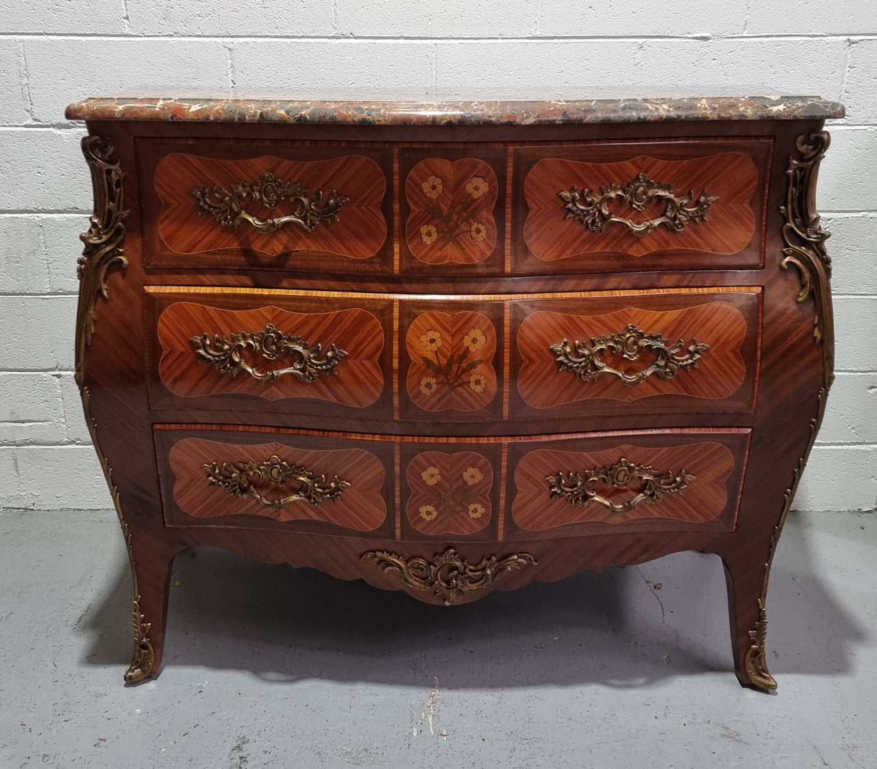 French Walnut and Kingwood Louis XV style marquetry inlaid commode with three drawers and a beautiful marble top. It is in good original detailed condition.