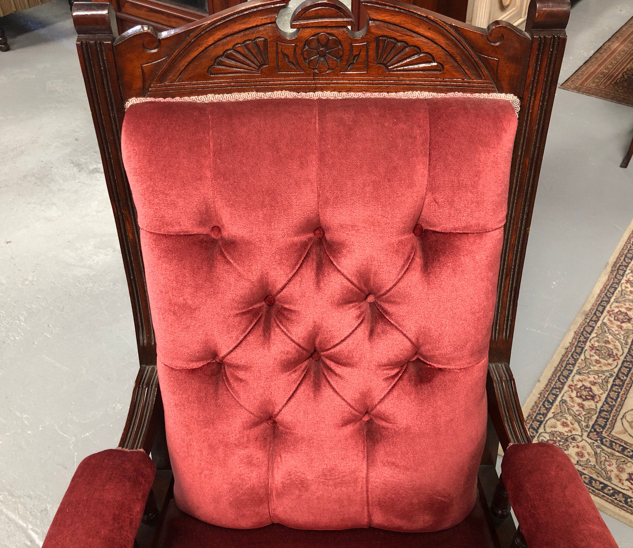 Beautiful pair of carved Edwardian arm chairs with lovely pink upholstery with button backs. In good condition.