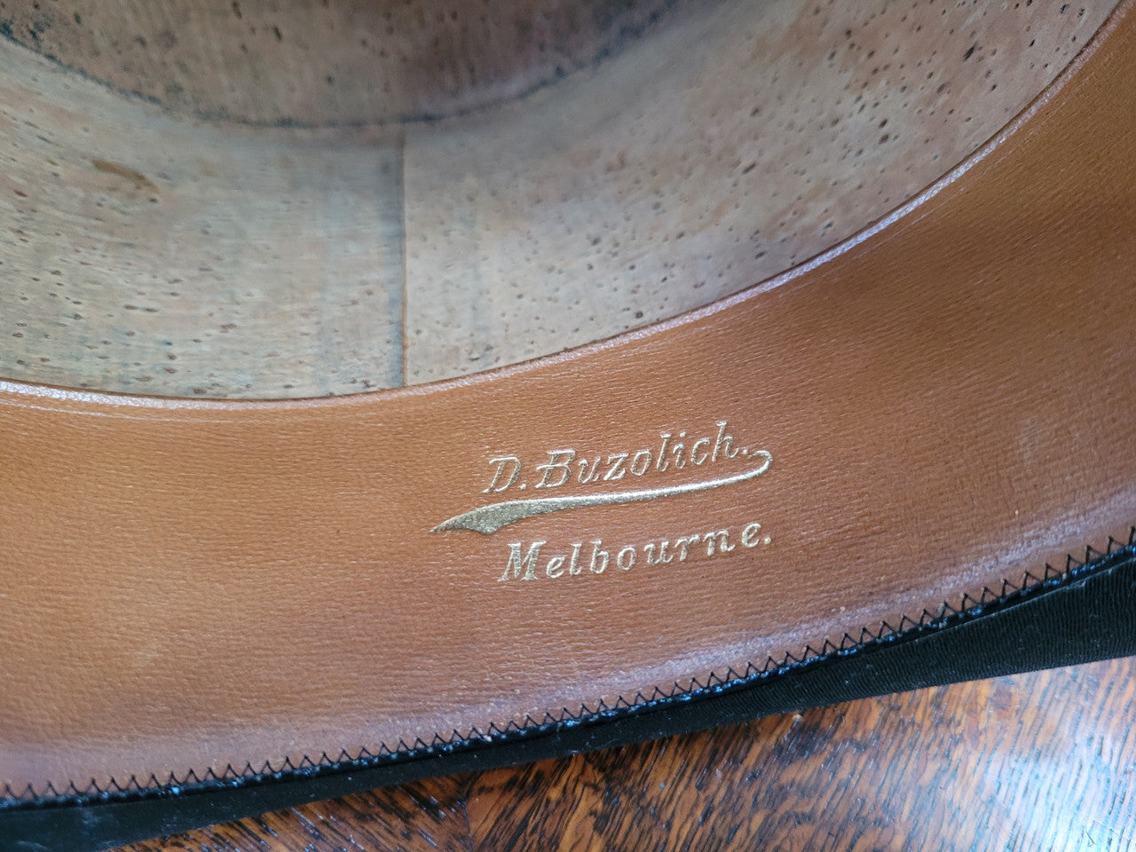 Black Silk Top Hat manufactured by the Buzolich Family, Melbourne between 1910 – 1927 (now City Hatters Flinders Street). Includes original Leather Hat Box with insert for hat. Hat in good condition, box shows wear and deterioration commensurate with age and has part labels from travel affixed.