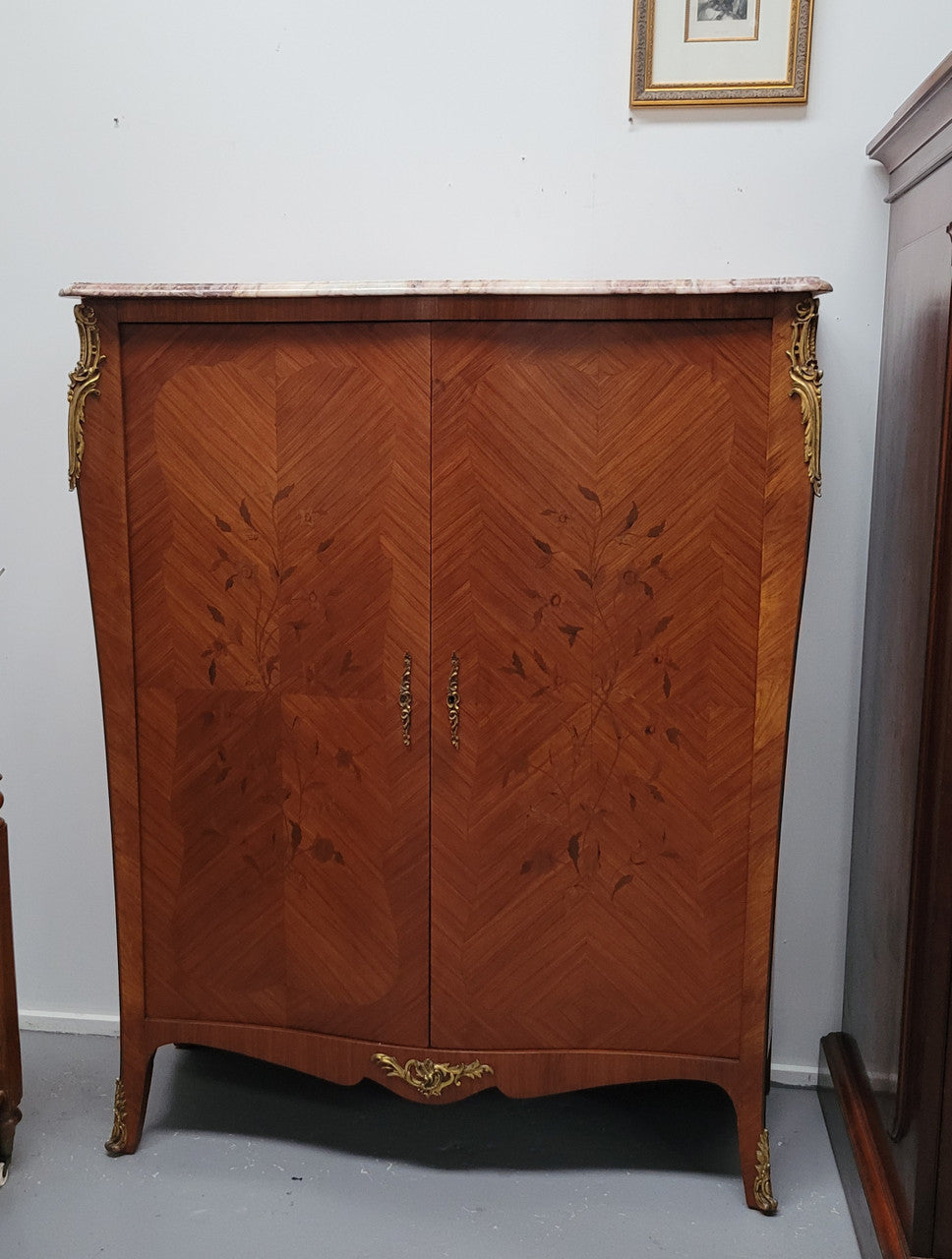 French Louis 15th style Kingwood marquetry inlaid two door cupboard with a beautiful marble top. It has three adjustable shelves and decorative ormolu trim. It has been sourced from France and is in good original detailed condition.
