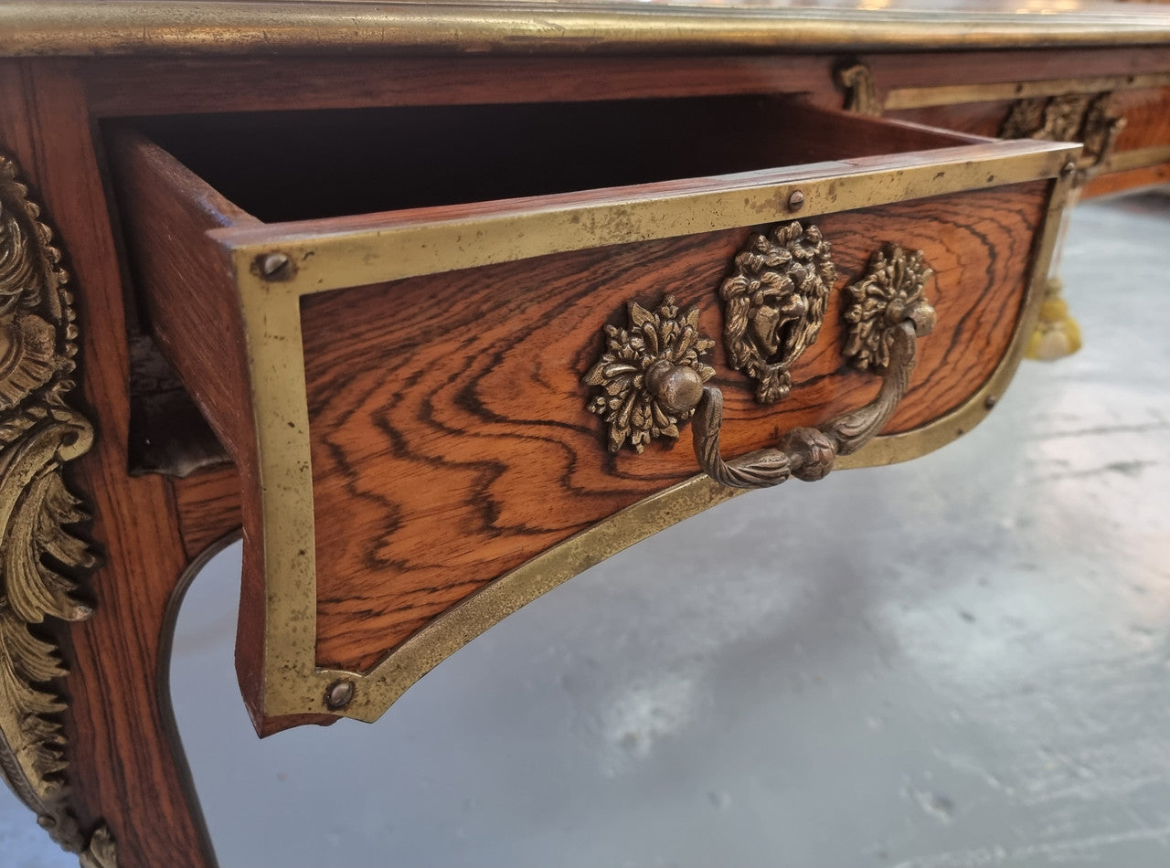 Beautifully fully restored French Antique Rosewood partners desk with beautiful ormolu detail and lovely tooled new leather top. There are three functioning drawers on one side for all your storage needs.