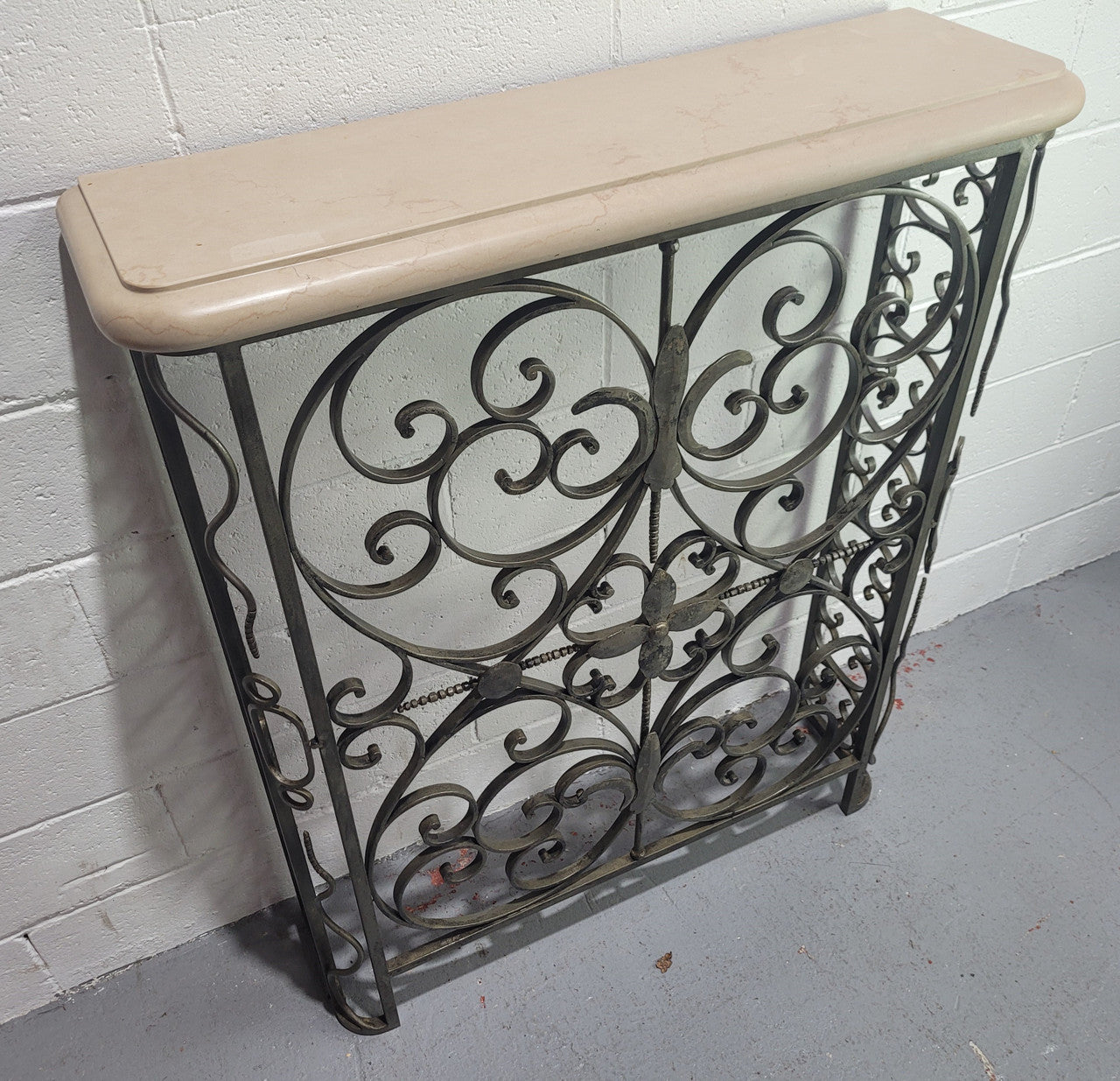Stunning Art Deco wrought iron and marble top console table. It has amazing decorative iron work at the bottom and a beautiful marble top. It is in good original detailed condition.