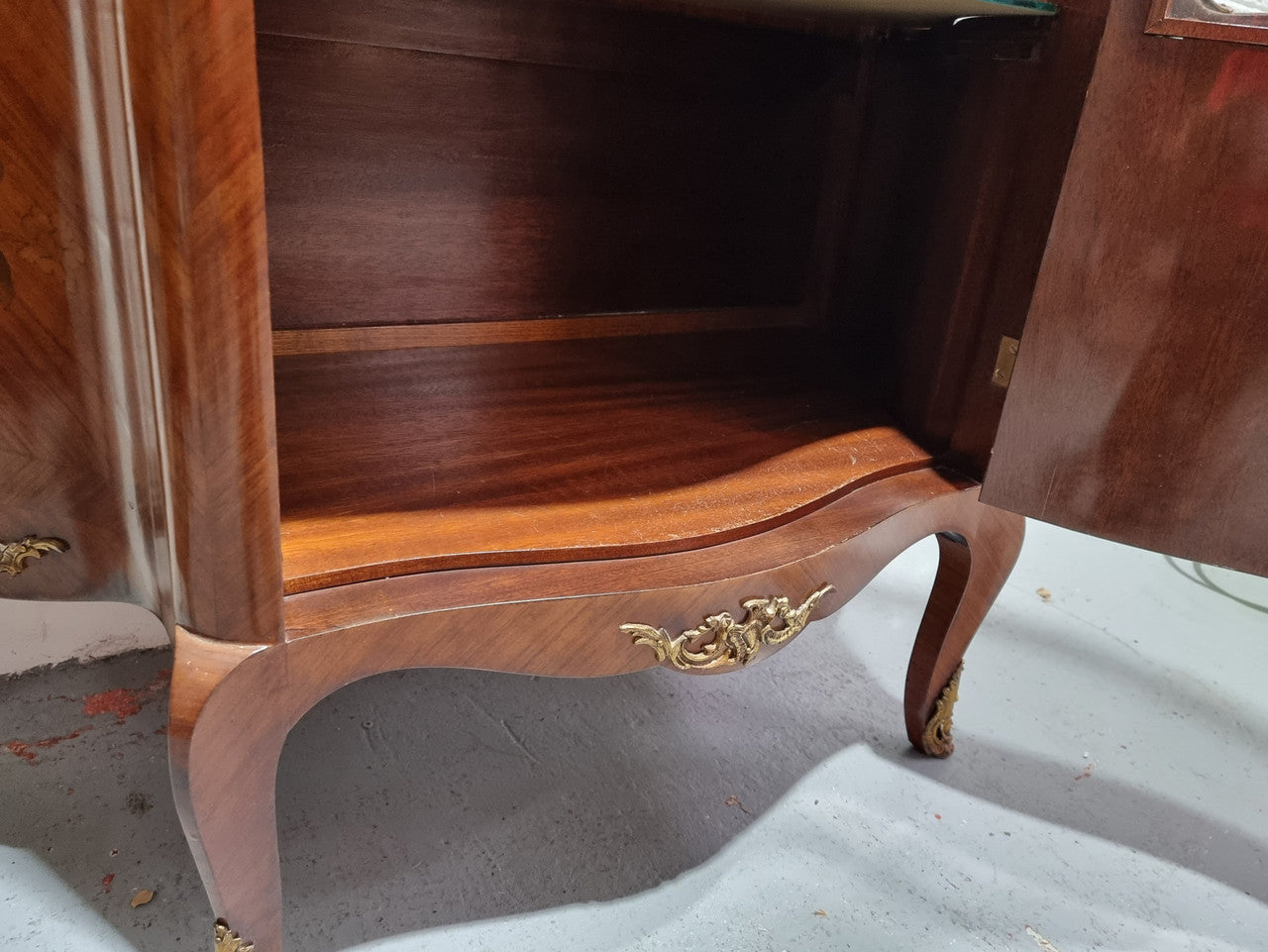 Grand French Walnut Louis XV style marble top vitrine. It has two glass shelfs and one mirrored shelf at the bottom and added storage at bottom. It is in good original detailed condition.