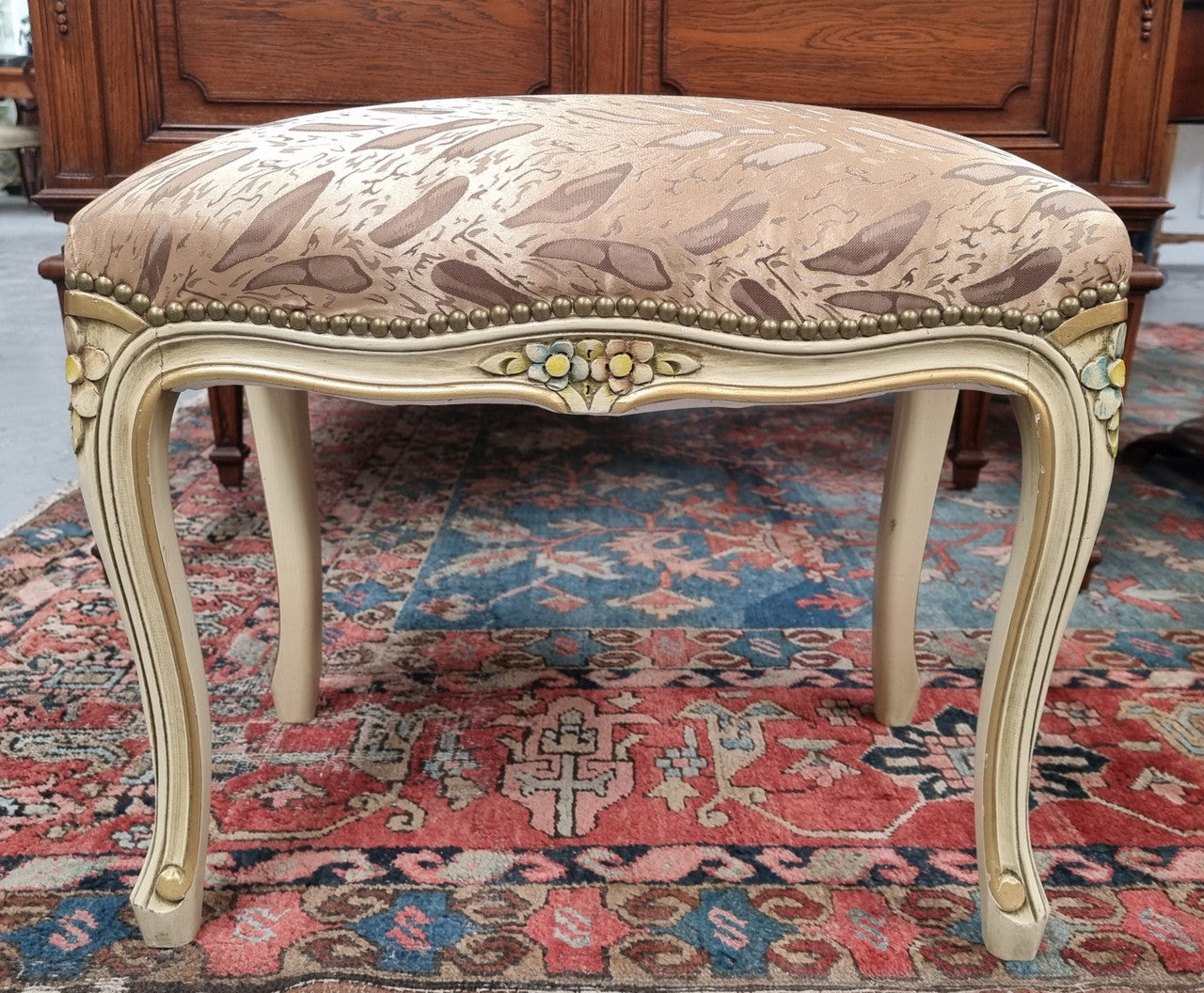 Appealing French Louis 15th style hand painted and gilded stool with good upholstery. In good original detailed condition.