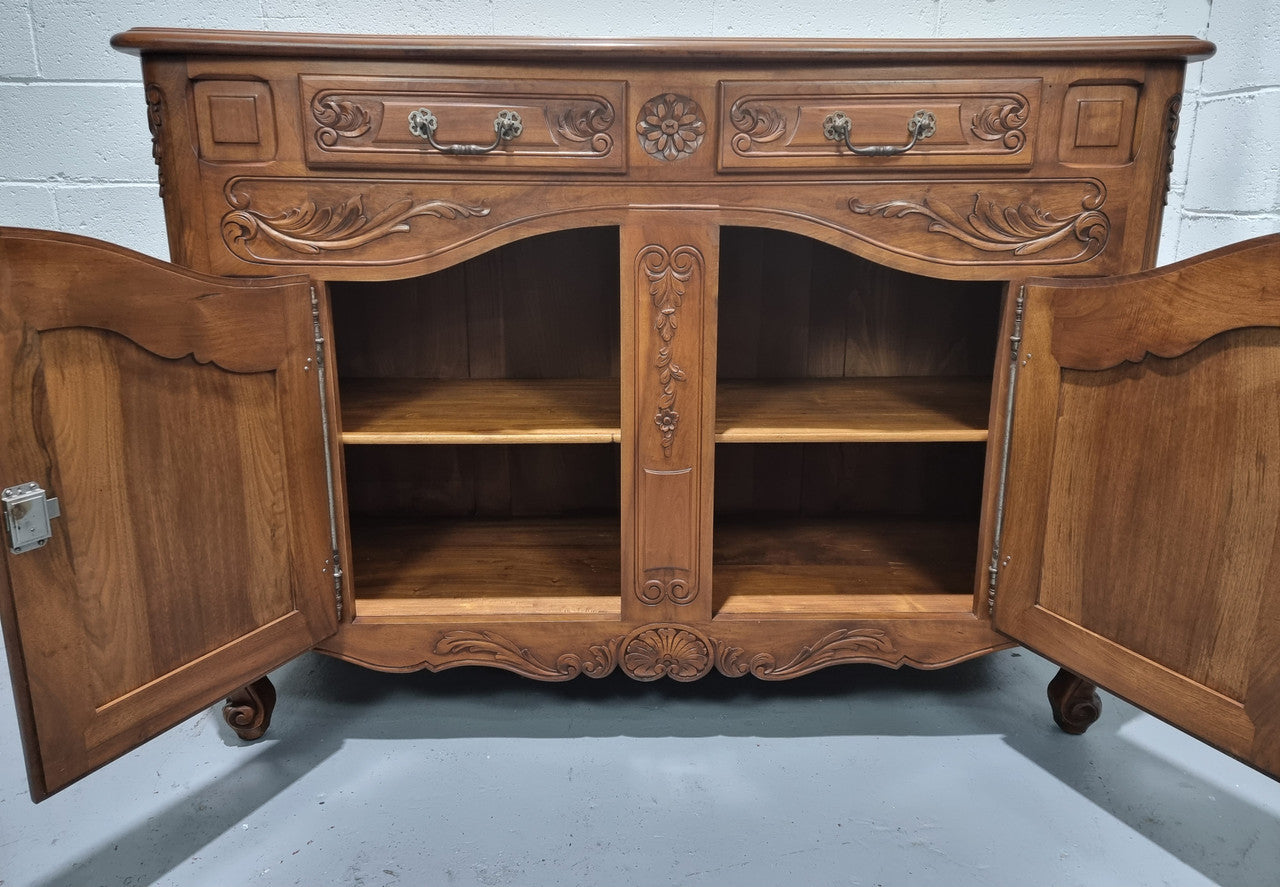 French Walnut two door buffet with parquetry top. It has two drawers and an adjustable shelf. In good original detailed condition and it has been sourced from France.