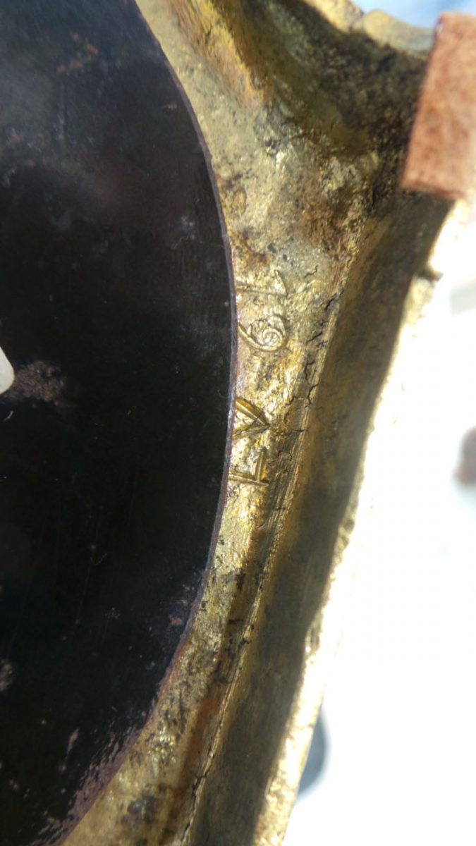 An antique signed French gilt bronze cupid candlestick in good original condition.