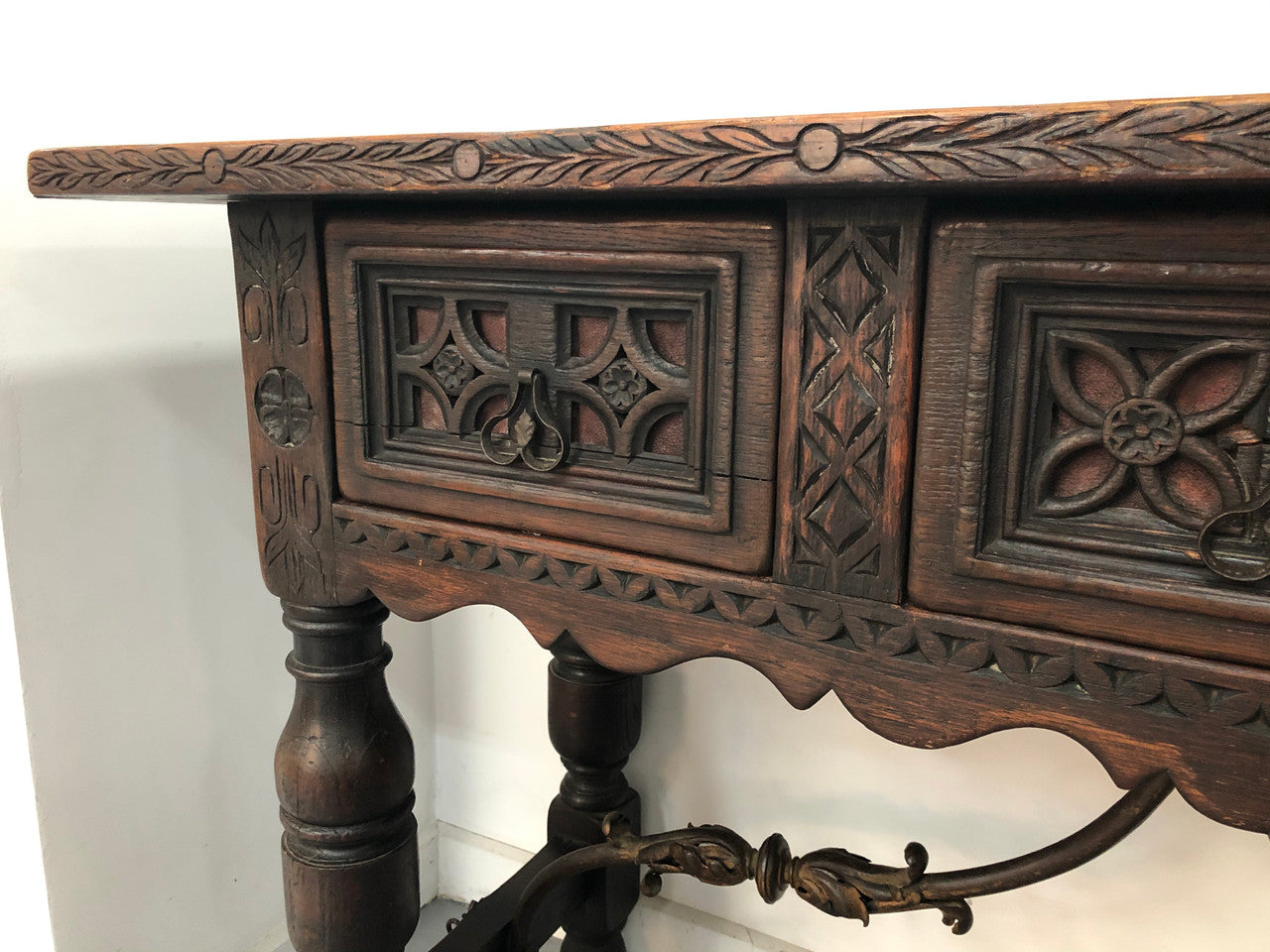 Spanish late 19th century carved oak three drawers console/side table. Superb wrought iron undercarriage. In good condition. Circa 1900's.
