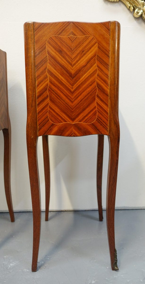 A pair of circa 1950 French marquetry inlaid Kingwood bedside cabinets, in the Louis XV style. In very good original condition.