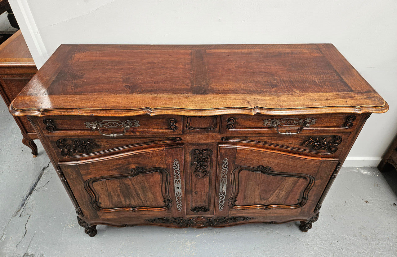 Attractive French Walnut Louis XV style two door two drawer sideboard featuring beautiful carving. Circa: 1930's. It has been sourced from France and it is in good original detailed condition.