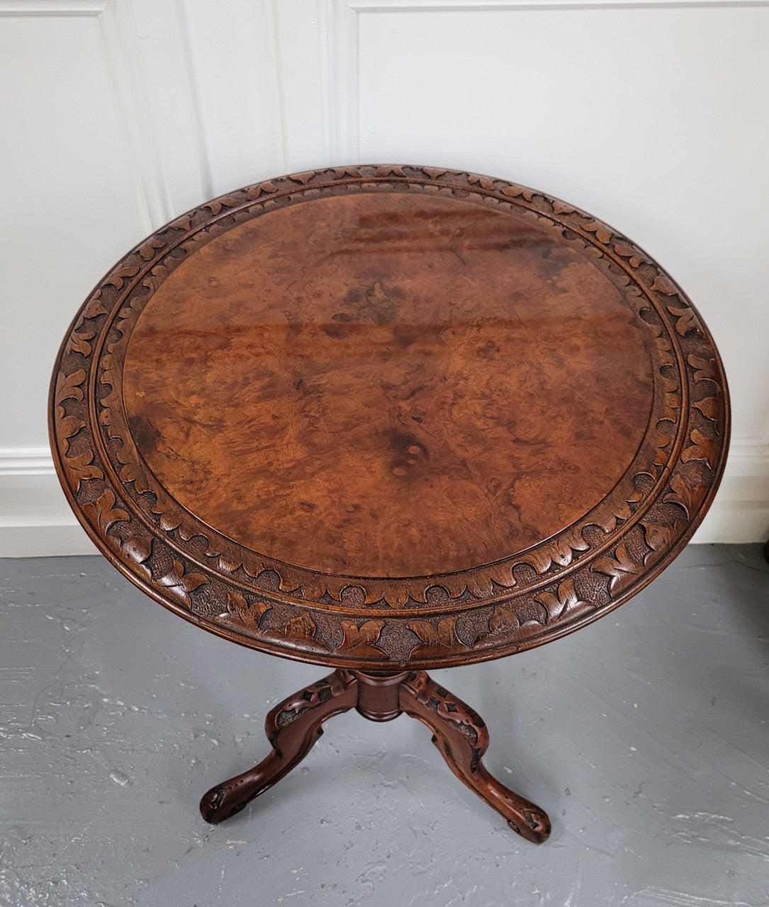 Rare early Victorian Irish Burr Walnut wine table. It has a beautiful carvings and a stunning burr walnut top, on a barley twist column and three shaped legs. It has been sourced locally and is in good original detailed condition. We also have a second table being sold separately which when together make a matched pair.
