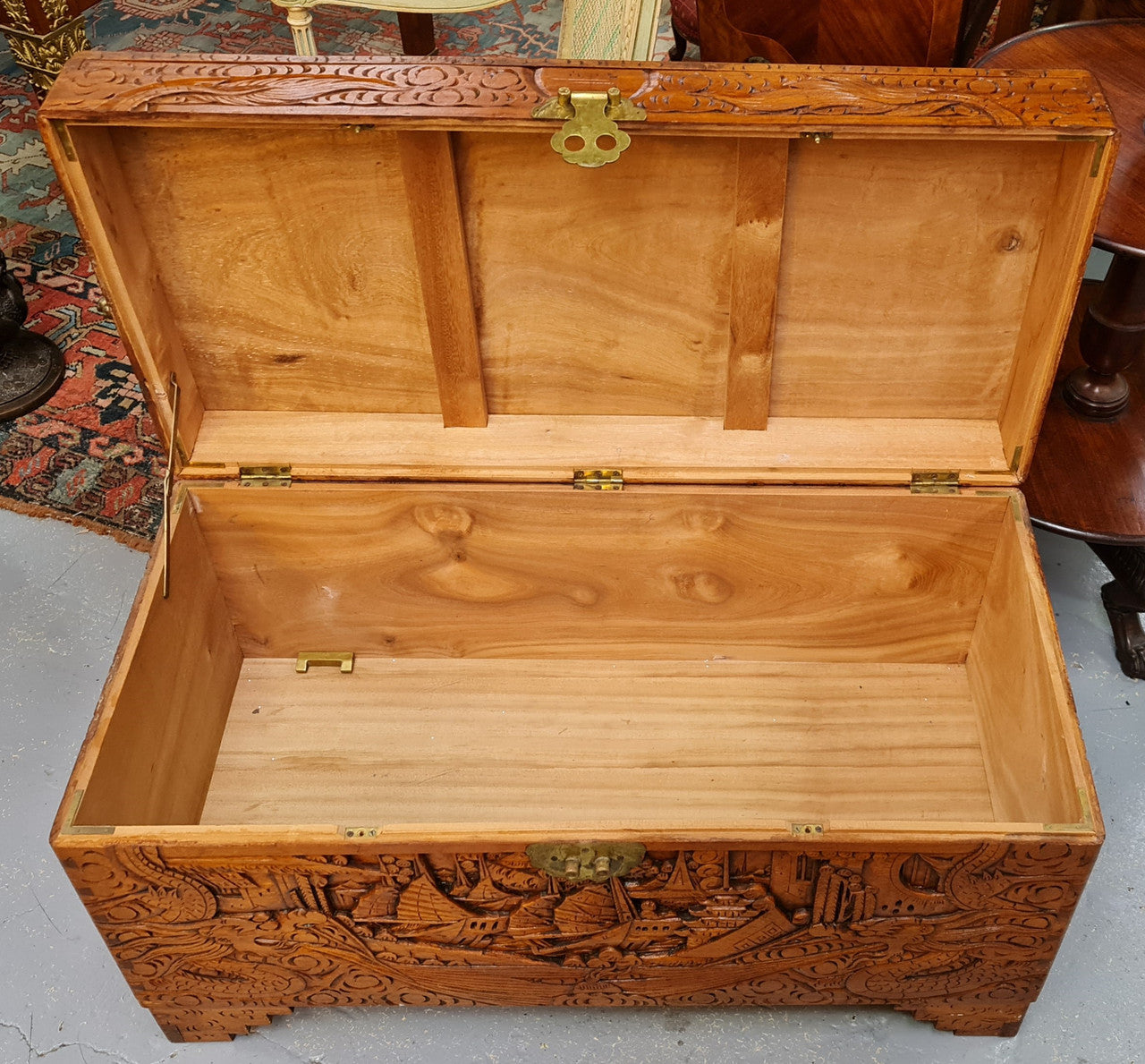 Vintage nicely carved Camphor wood chest. It has amazing carvings of boats, dragons and temples. It is in good original detailed condition.