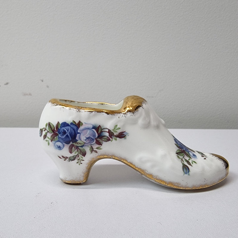 A lovely pair of Royal Albert China shoes in good original condition. Stamped on the sole 'Moonlight Rose: Royal Albert Bone China, England ©1987.