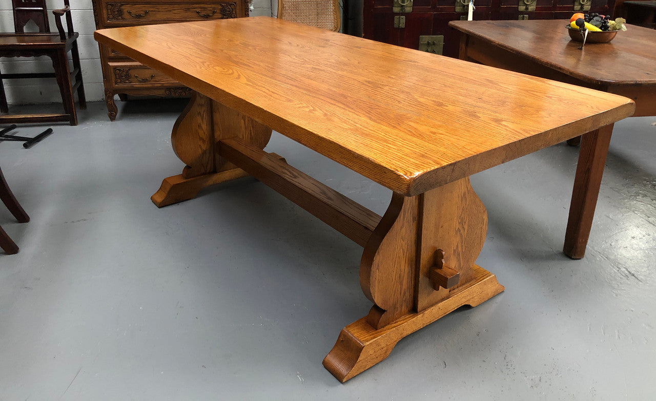 A French Style Oak stretcher base table with amazing wood grain. Can comfortable sit 6-8 people and is in original detailed condition.