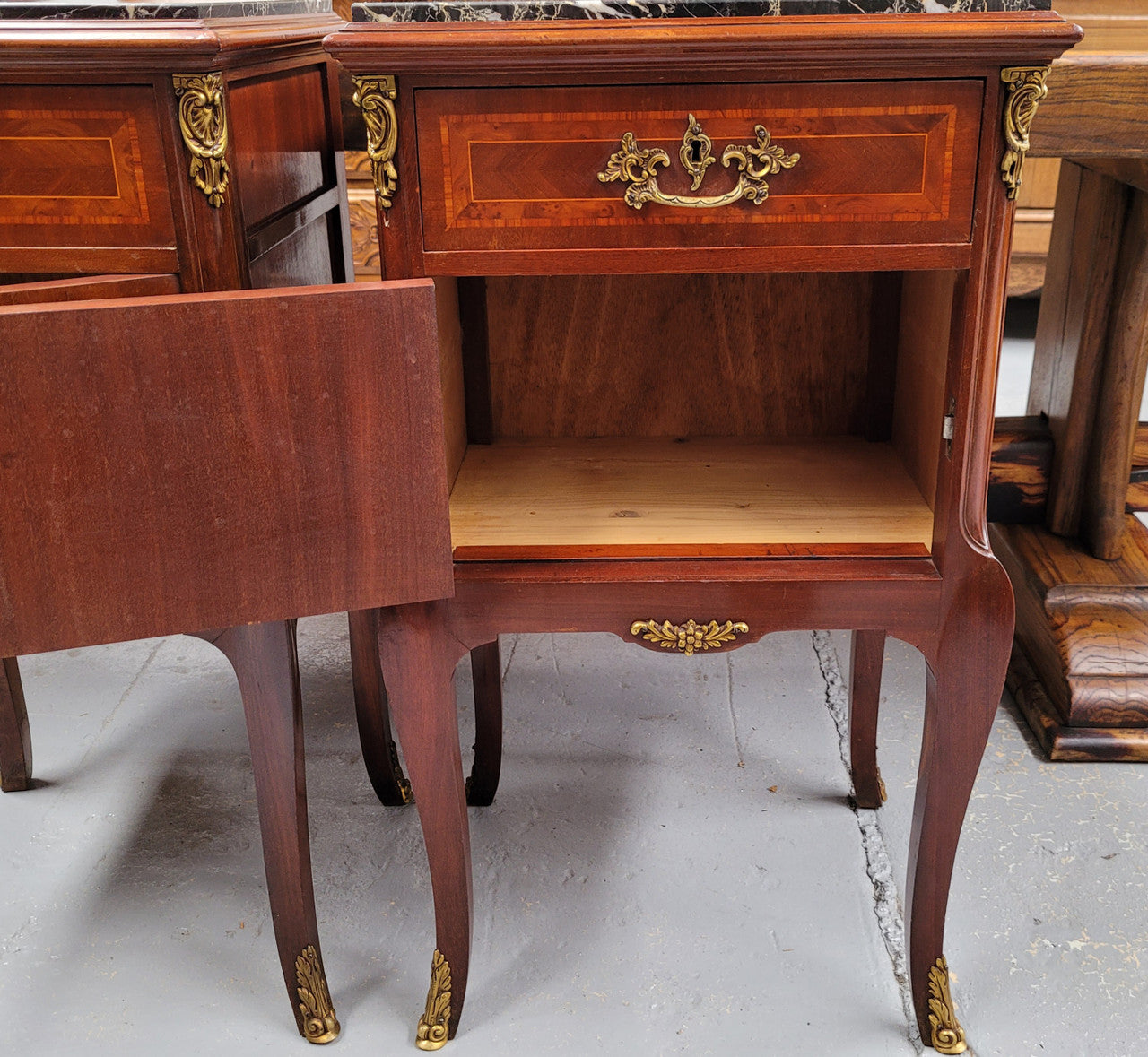 Appealing Louis XV style high quality bedside cabinets with black Portoro marble top and bronze mounts. They have been sourced from France and are in good original condition.