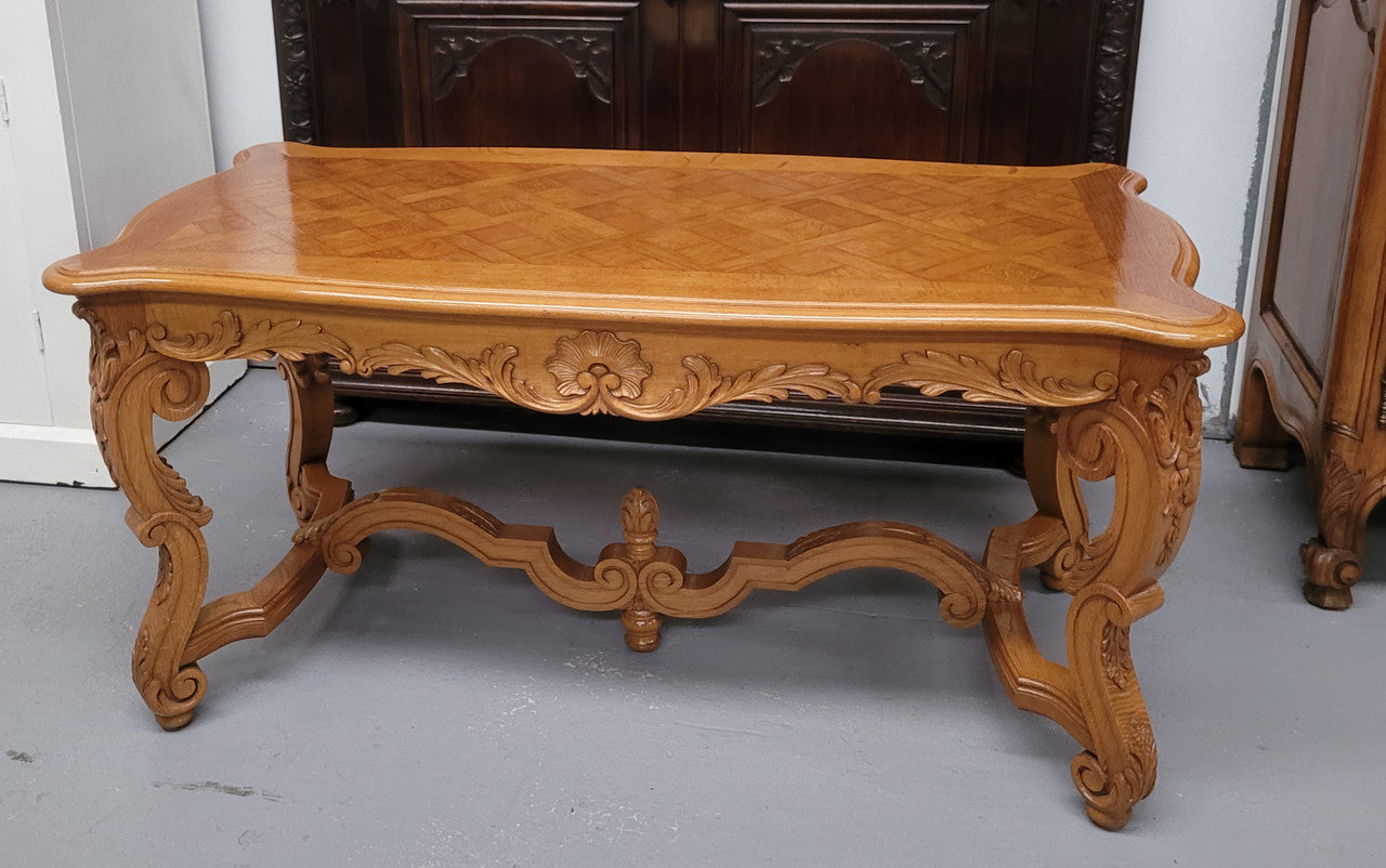 French Oak parquetry top coffee table with decorative carved base. It is in good original detailed condition.