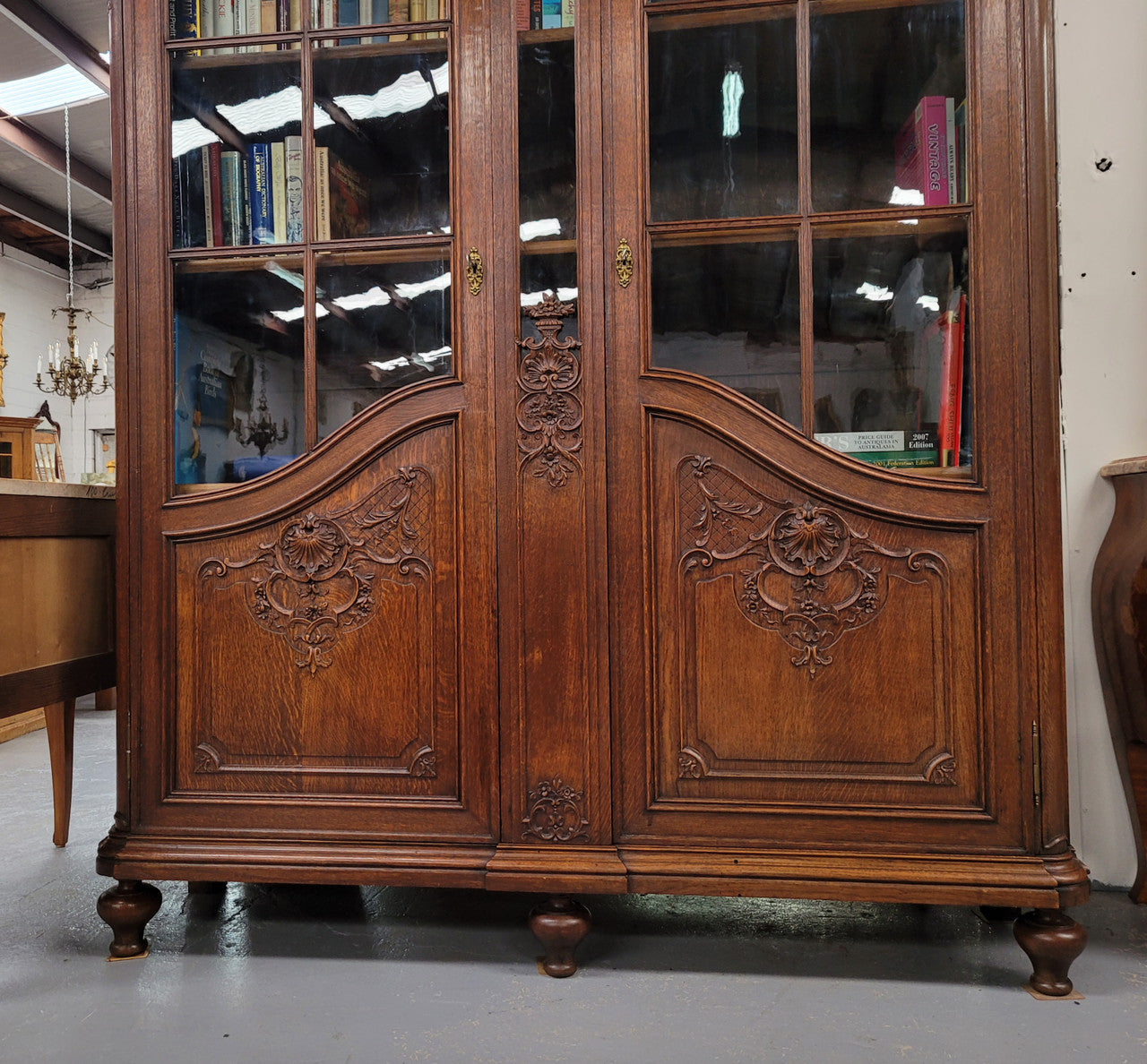 Substantial French Oak Louis 15th Style large two door bookcase. Adjustable shelves and very decorative carving. In good original detailed condition.