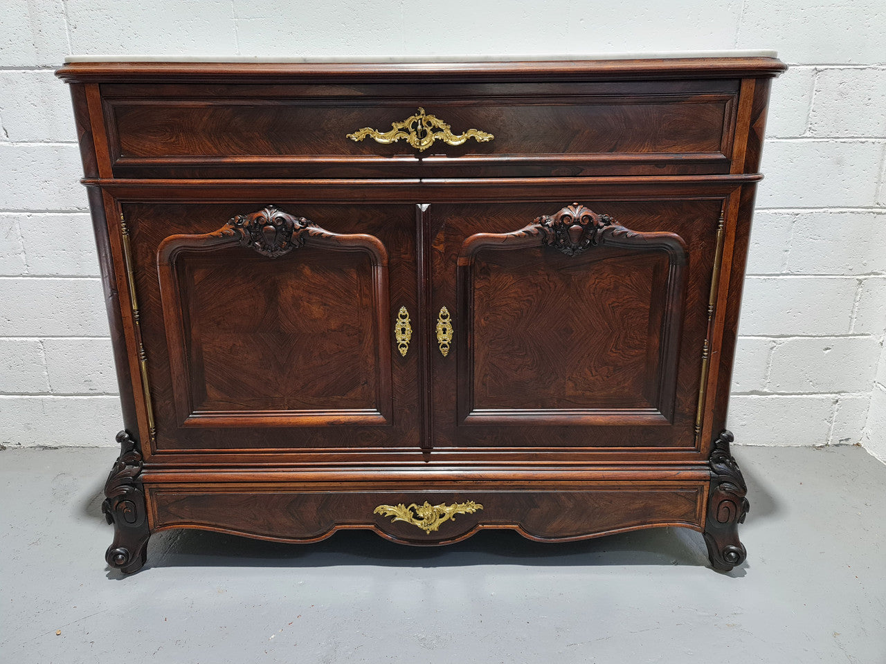 Stunning Rosewood Marble Topped Secretaire with two cupboards. Cupboards open to three fitted drawers and an additional secret drawer beneath the cupboard. All sitting on lovely carved legs and decorated with ormolu mounts. Circa: 1860. In good original detailed condition.