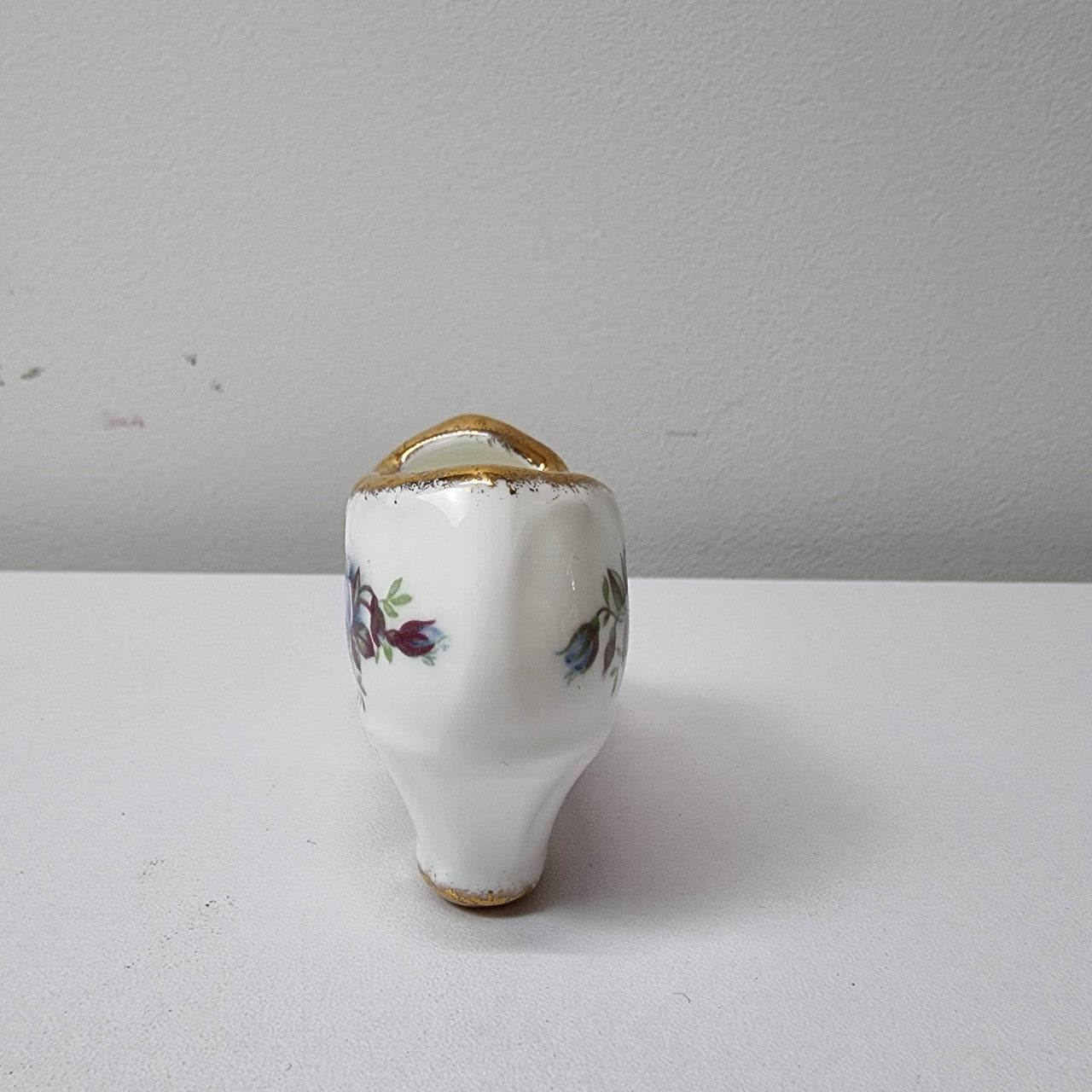 A lovely pair of Royal Albert China shoes in good original condition. Stamped on the sole 'Moonlight Rose: Royal Albert Bone China, England ©1987.