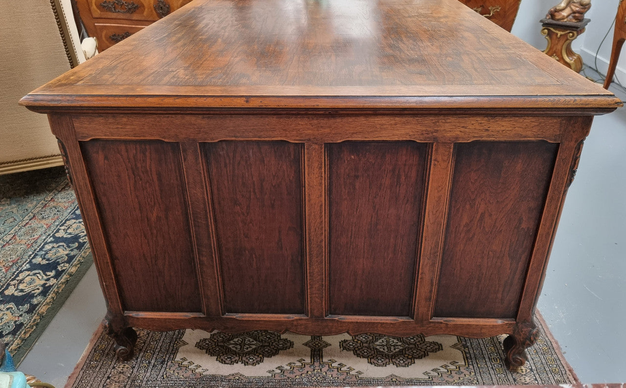 Fabulous Louis XV style French Oak beautifully carved full partners desk. Both sides have a functioning drawer in the middle and two cupboards either side. On both sides one cupboard door opens up to four smaller internal drawers. Plenty of storage space and a large top surface to work on. It is in good original detailed condition.