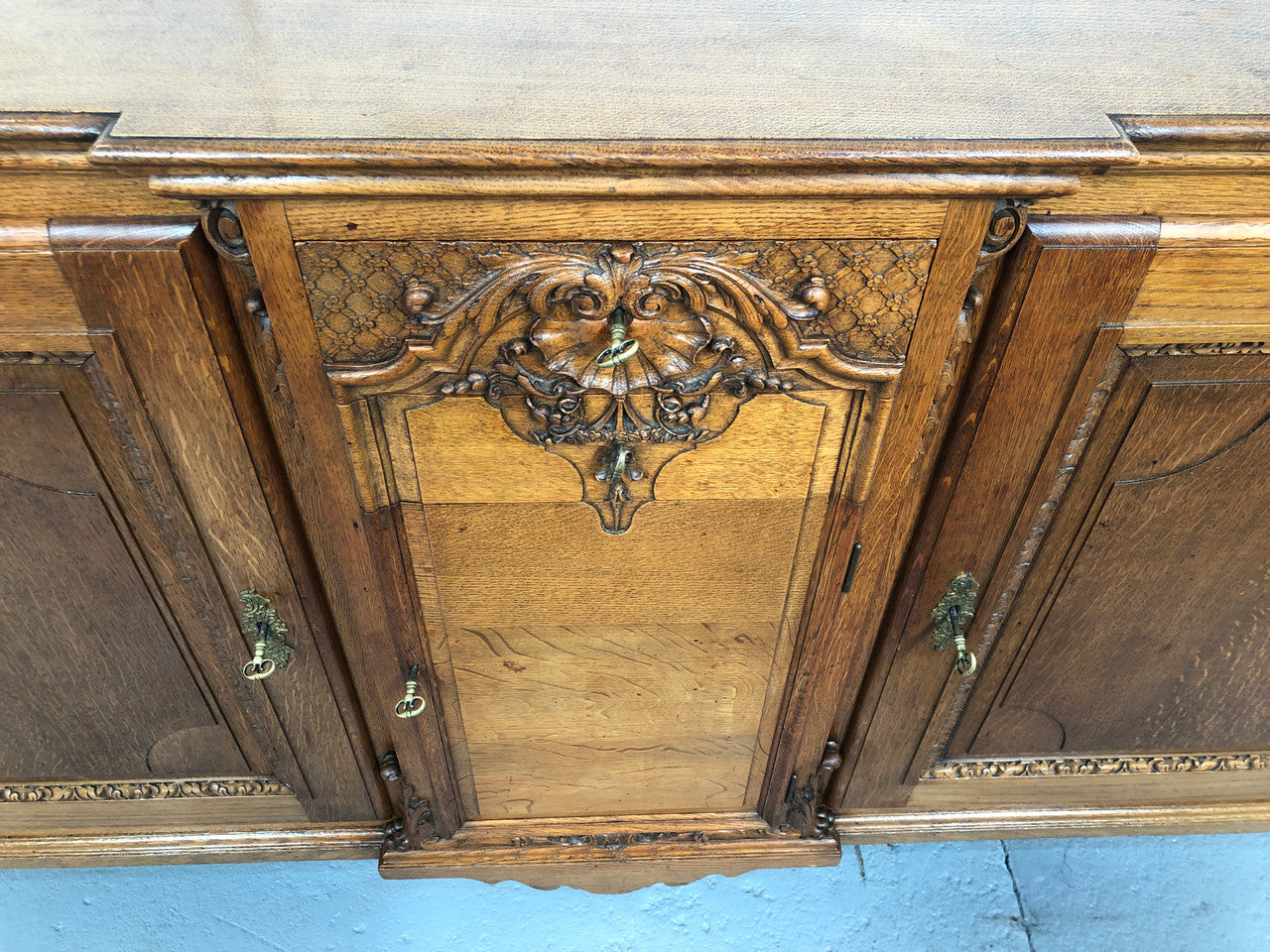 19th century French Oak three door, two drawers buffet with beautiful detailed carving. In good original detailed condition.
