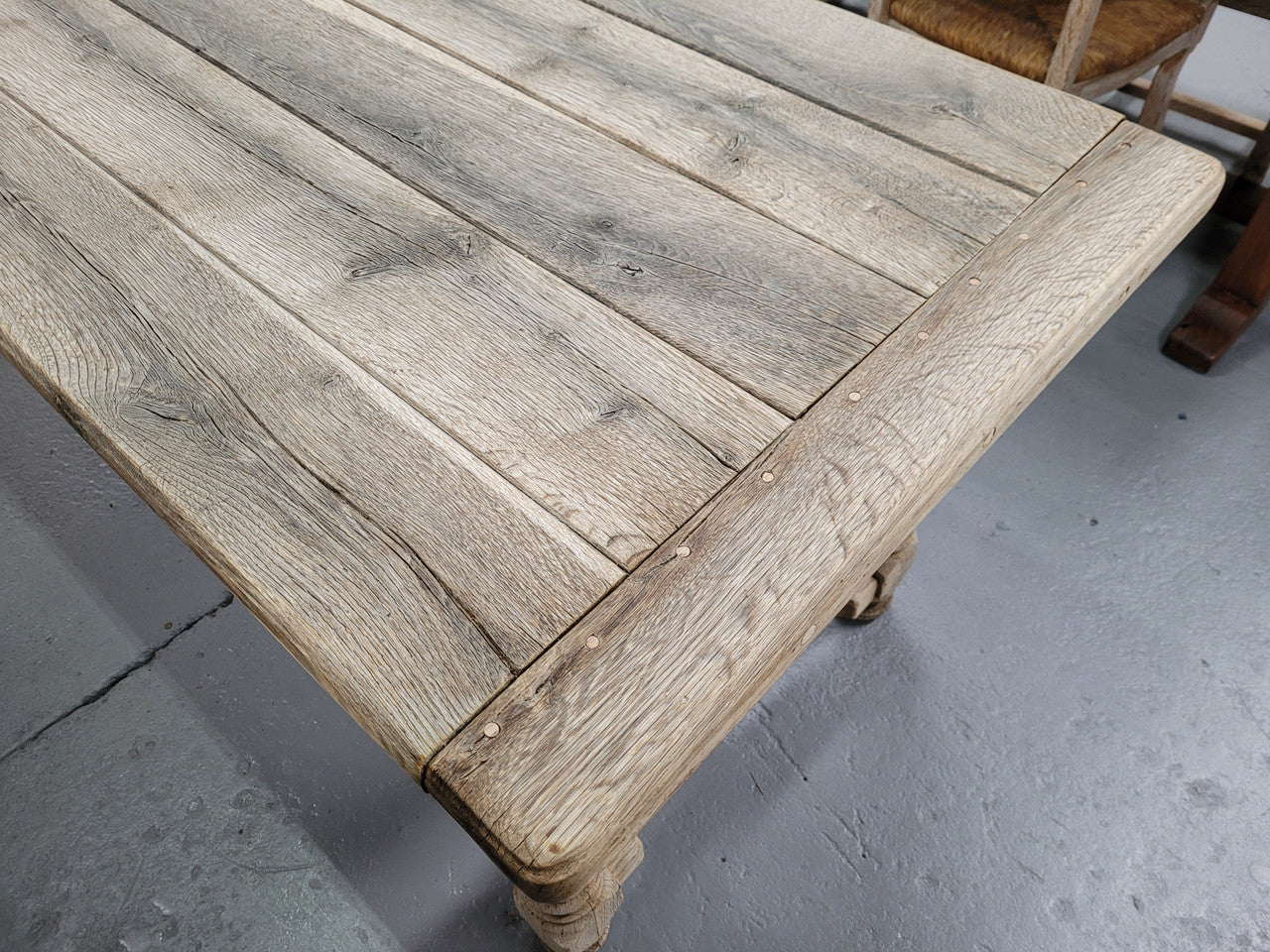 French stripped Oak pedestal stretcher base Farmhouse table with two drawers on either side of table. Features raw wood that could be used as is for a distressed look, or finished and waxed for a more refined look.