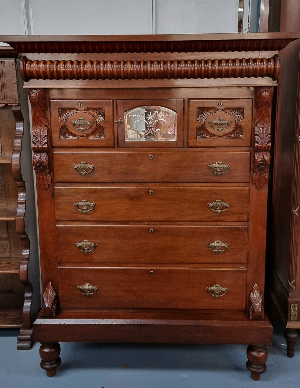 A 19th Century Scottish Mahogany tall boy/ chest of six drawers with small cabinet section at the top. Beautiful carvings and easily comes apart into three sections making transport for moving into place easy. In good original detailed condition.