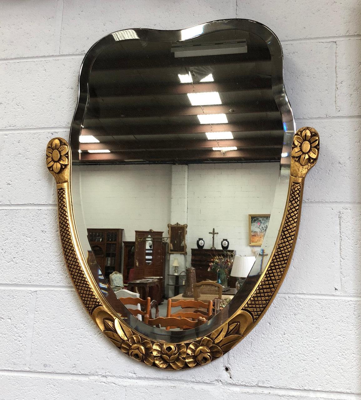 Beautiful French decorative Art Deco giltwood wall mirror with lovely floral detail. Contains its original mirror and is in good original condition.