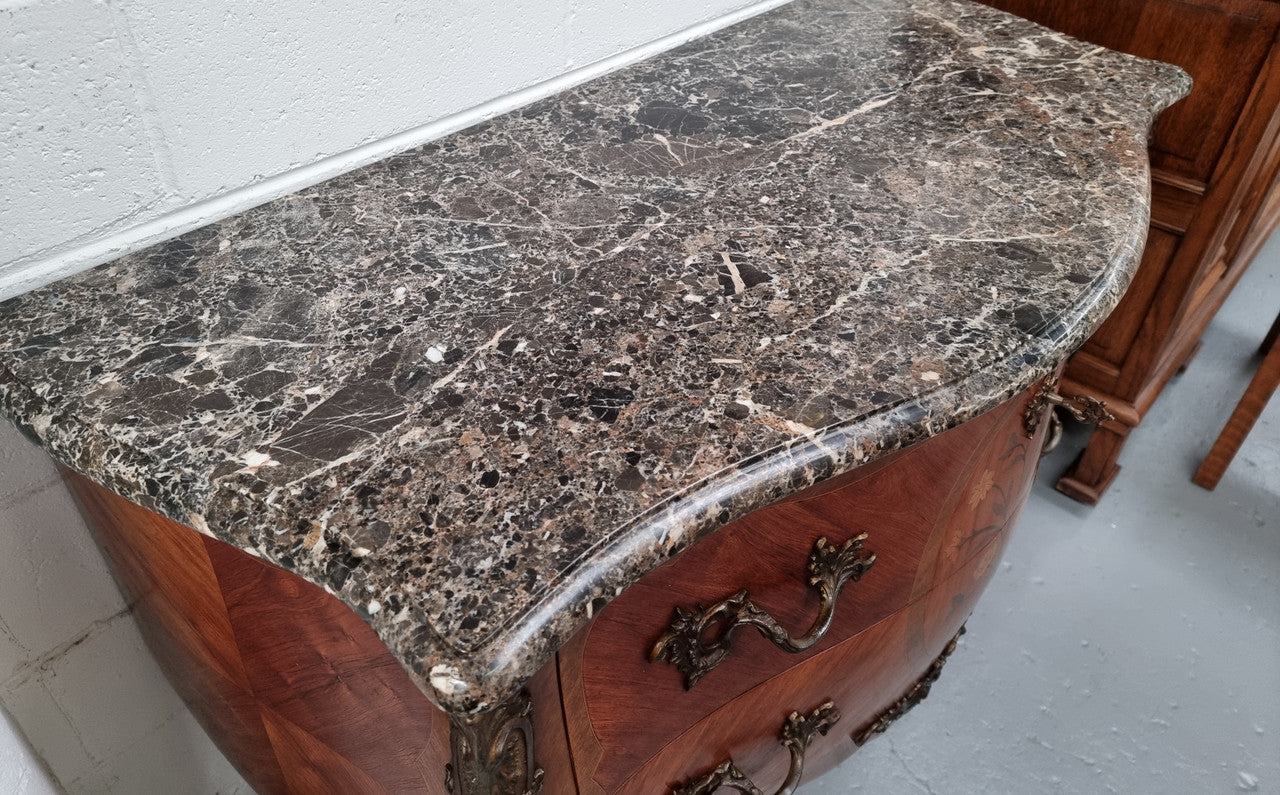 Beautiful French walnut Louis XV style two drawer commode. With a lovely floral marquetry inlaid design and marble top. It is in good original detailed condition.