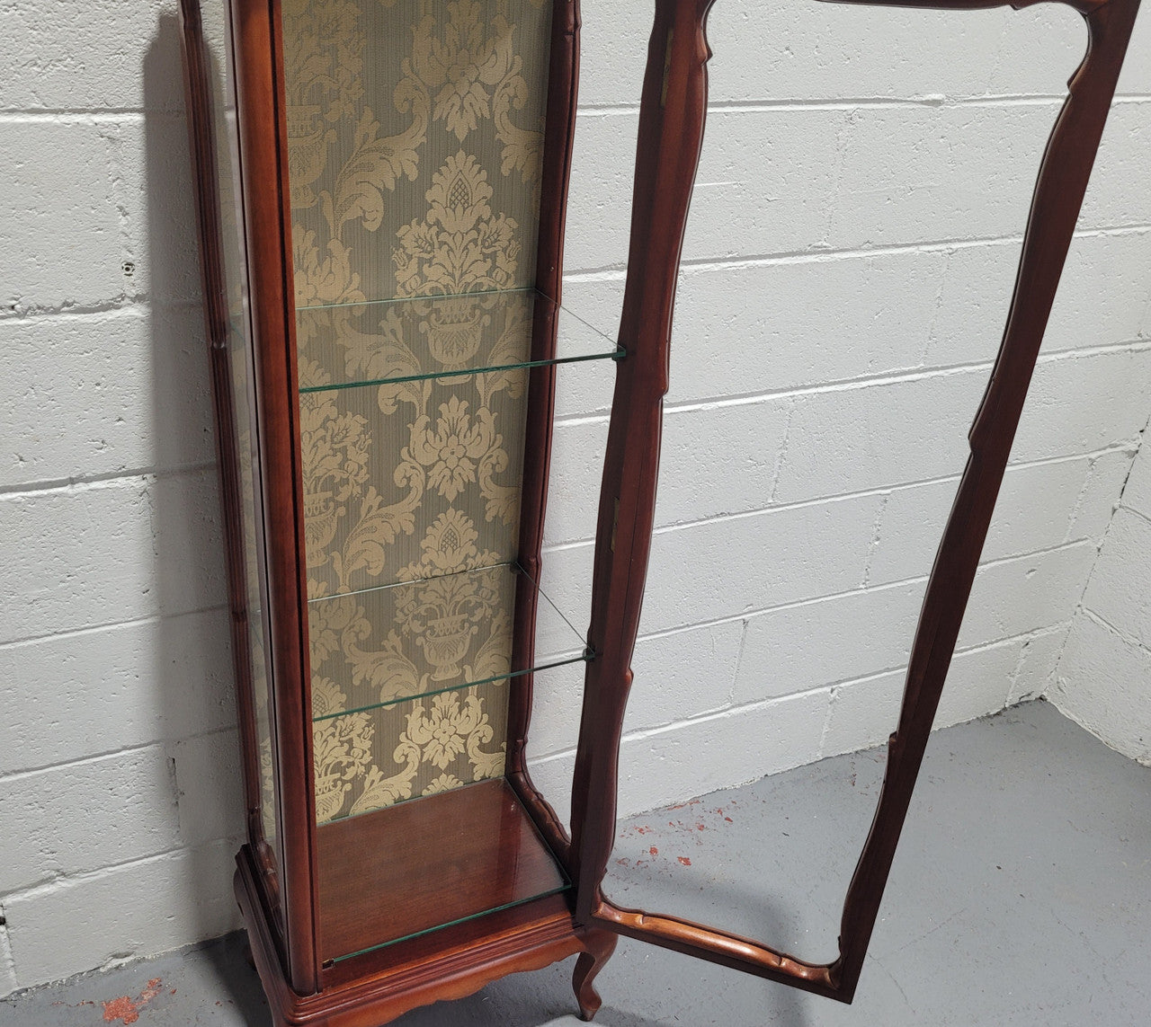 French Louis XV style small scaled display cabinet with marble top. It is of pleasing proportions with a lovely olive french damask fabric back and two glass shelves. In good original detailed condition.